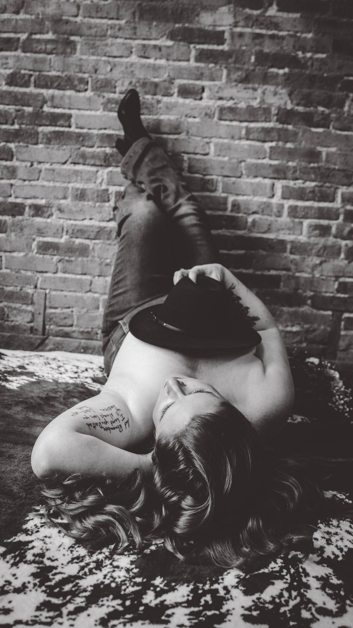 Black and white photo series showing artistic poses on wooden surface with scattered flower petals.