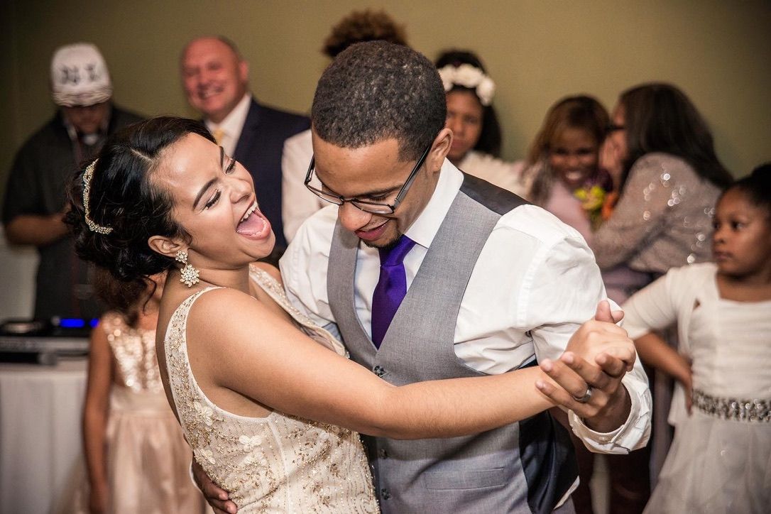 Wedding reception dance floor moments captured in warm ambient lighting.
