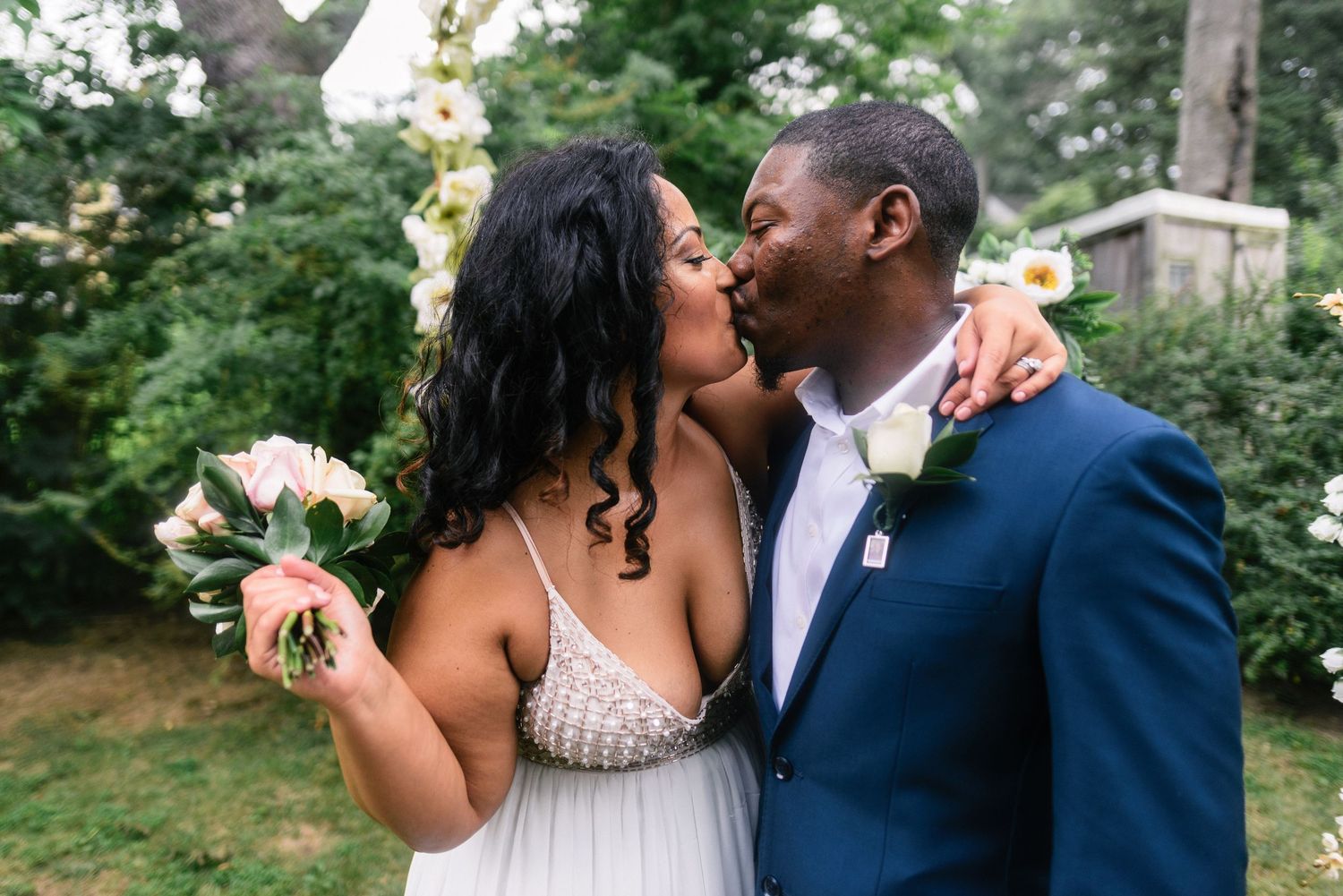 A romantic outdoor wedding photoshoot with a couple sharing intimate moments in a lush garden setting.