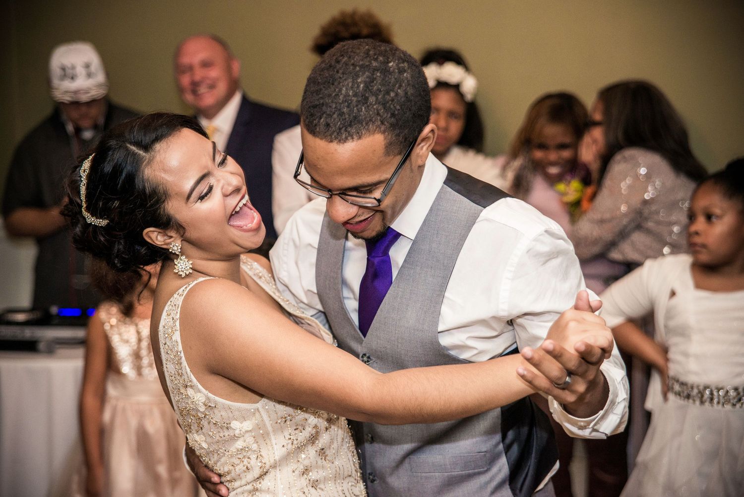 Couples dancing and celebrating together on a wedding reception dance floor.