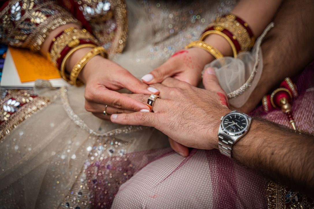 Detail shots of hands with jewelry and traditional Indian wedding bangles.