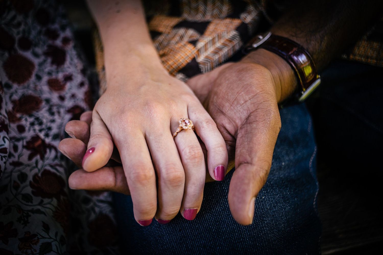 Close-up shots of hands with engagement rings showing various angles and poses against a dark background.