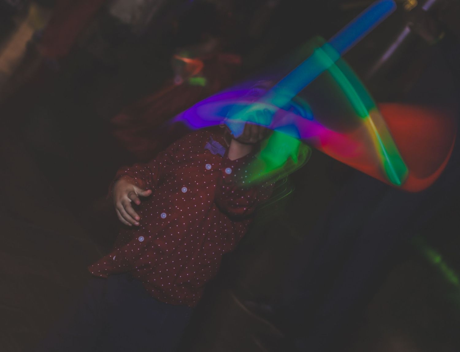 Abstract light painting photography with colorful neon streaks against black background.