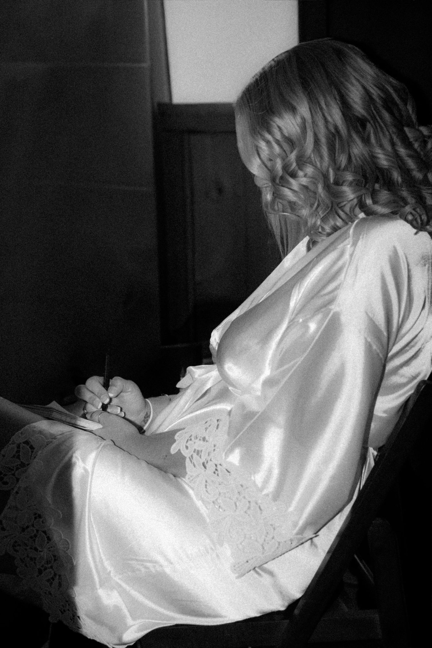 Close-up of white satin wedding attire with delicate embroidery details.
