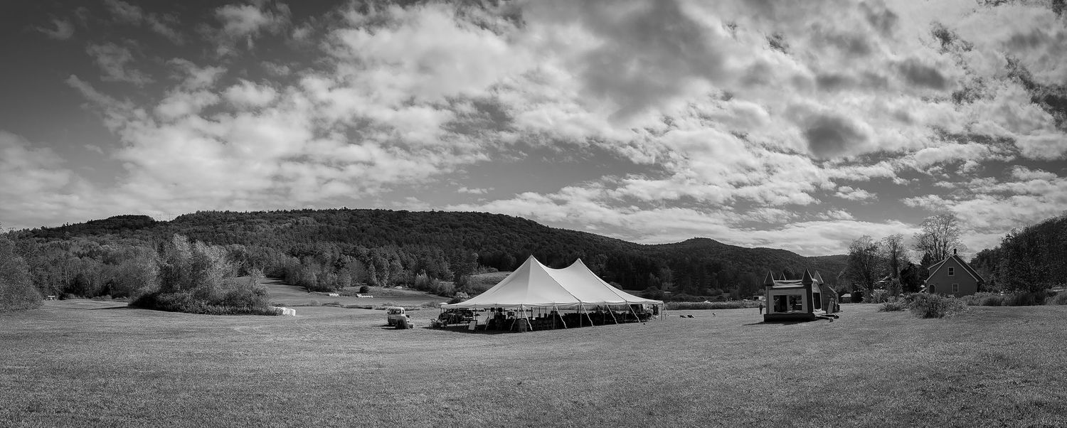 Panoramic wedding andscape view of mountains and cloudy skies in black and white.
