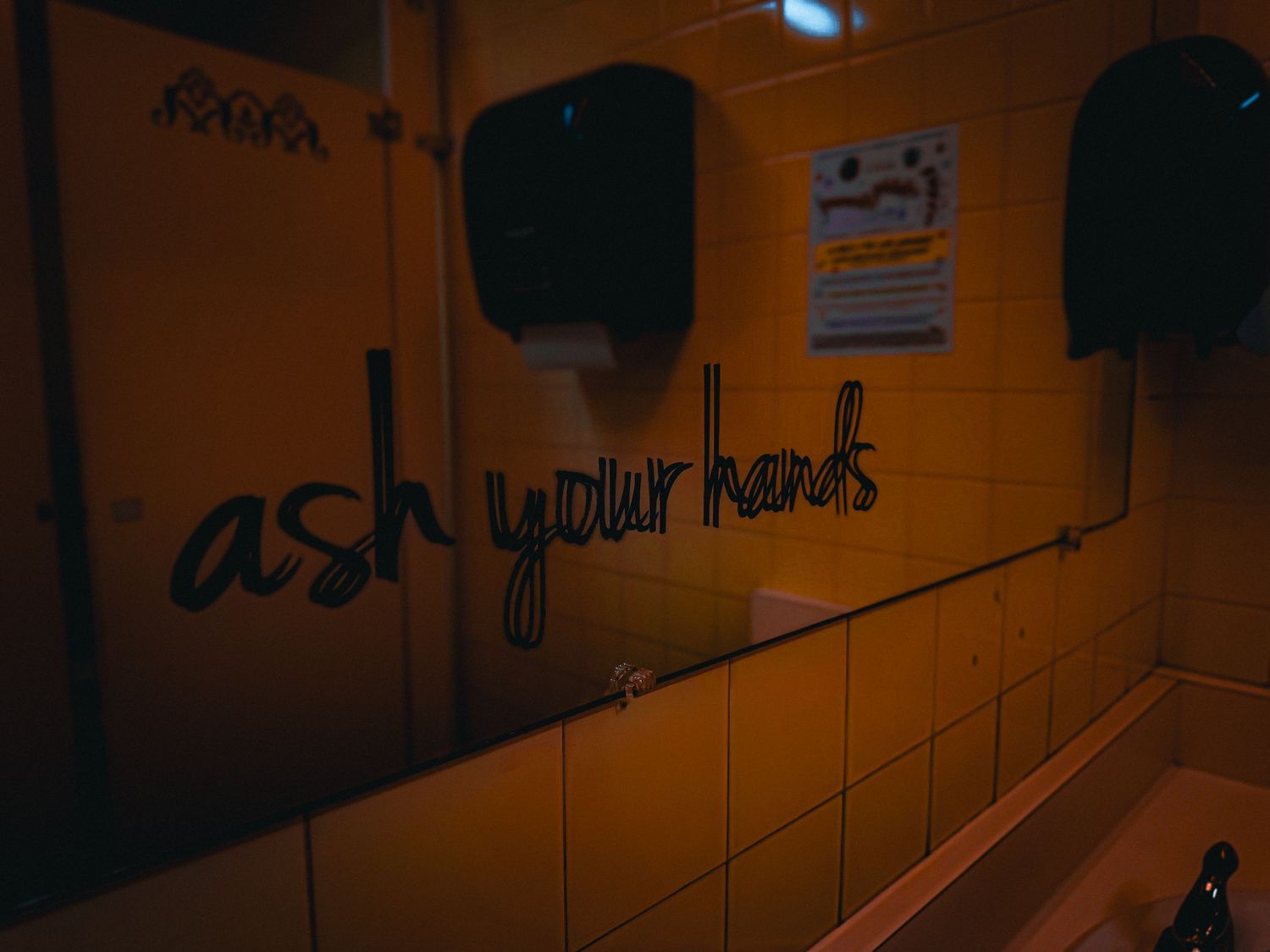 Bathroom Graffiti in dim lighting.