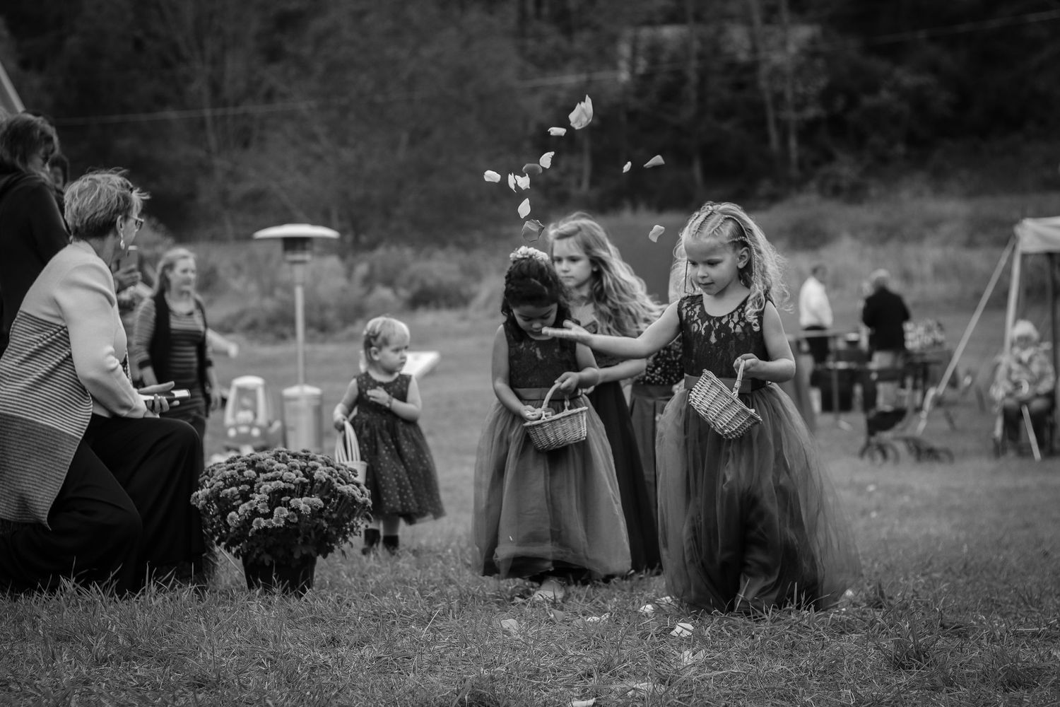 Black and White capture of flower girls walking down the aisle.