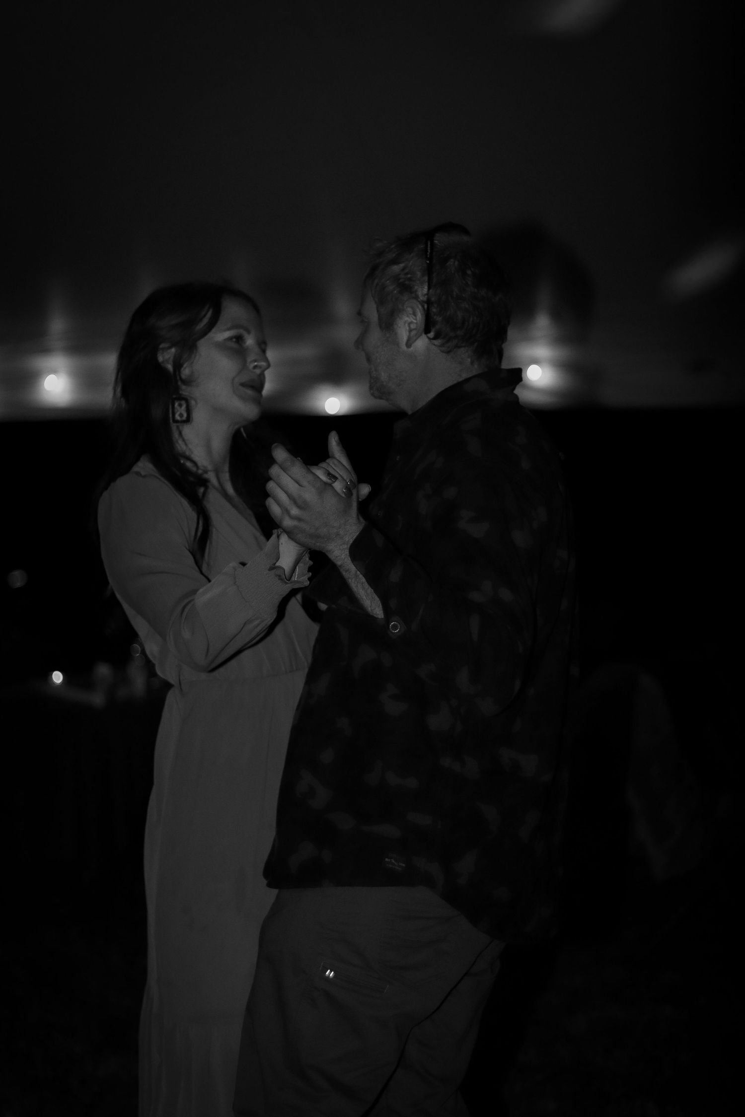 Dark dance scene with silhouettes against dim lighting.