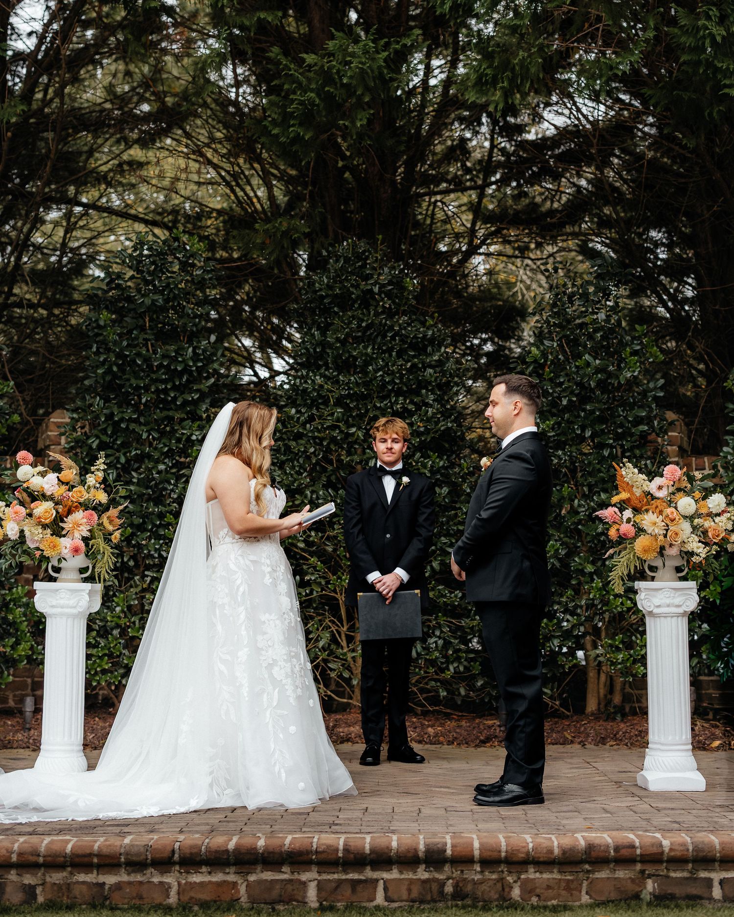 A wedding ceremony sequence shows a couple exchanging vows in front of white pillars with orange floral arrangements outdoors.