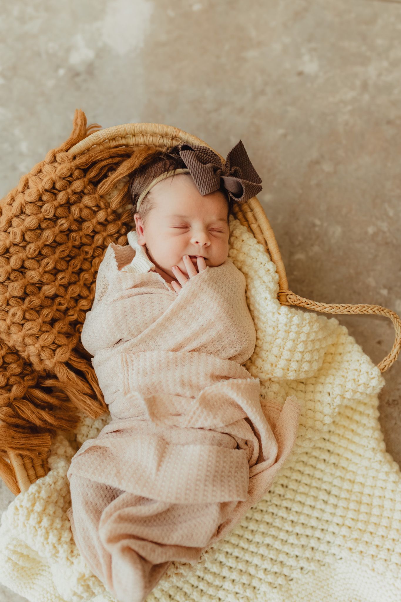 Bradenton in-home newborn photography featuring parents cuddling their newborn in a cozy lifestyle session. infant alone in a basket
