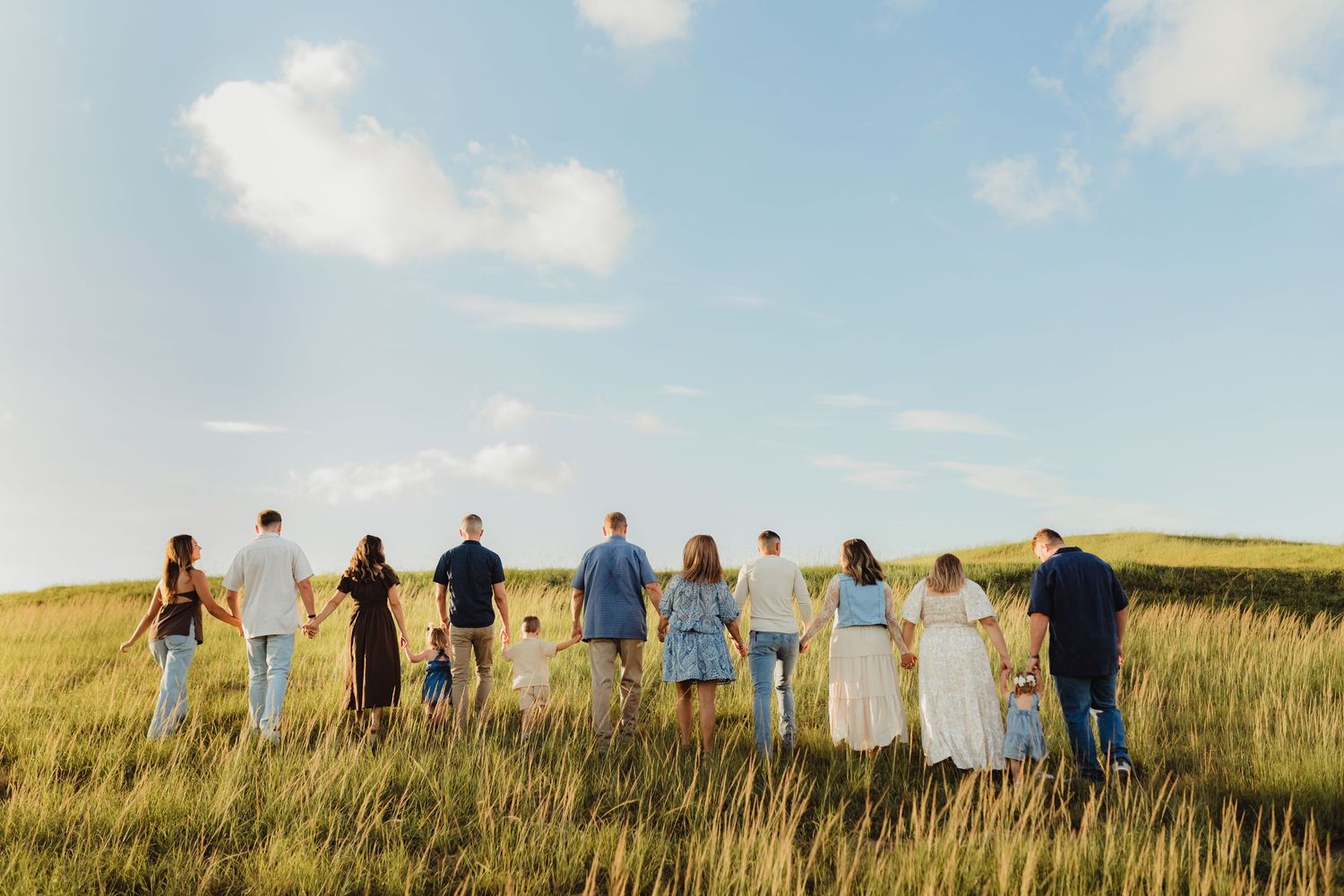 Bradenton extended family photography featuring multiple generations holding hands during a relaxed outdoor family session.
