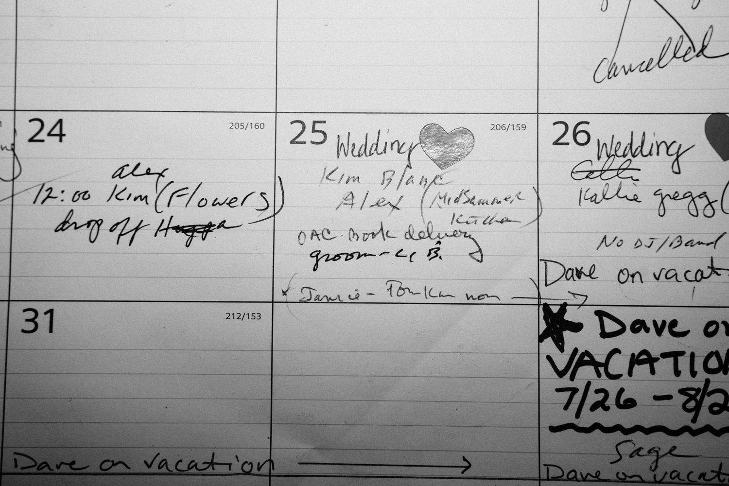 A handwritten calendar marks a wedding date with planning notes and vendor reminders in pencil.
