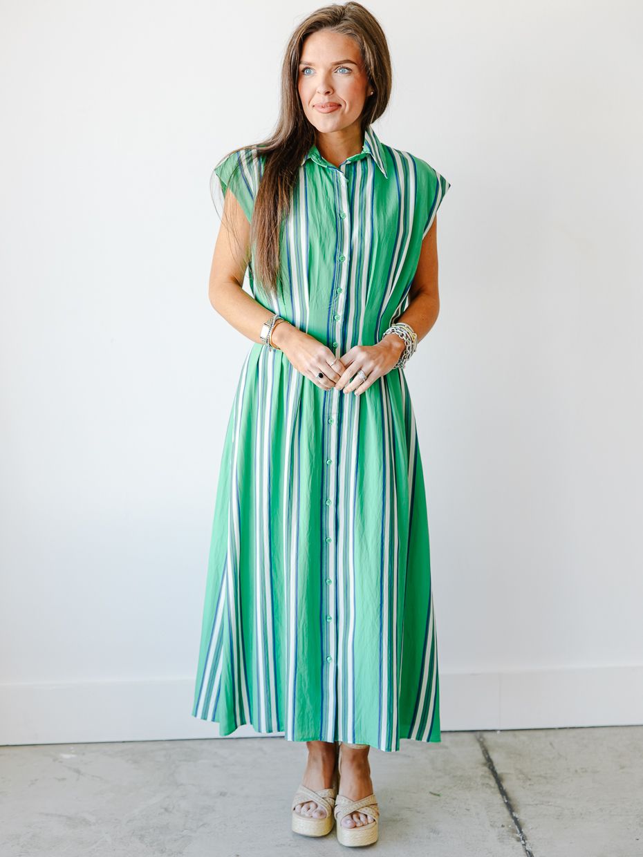 Woman wearing a green multistripe sleeveless collared midi shirtdress with cap sleeves and espadrille wedges.