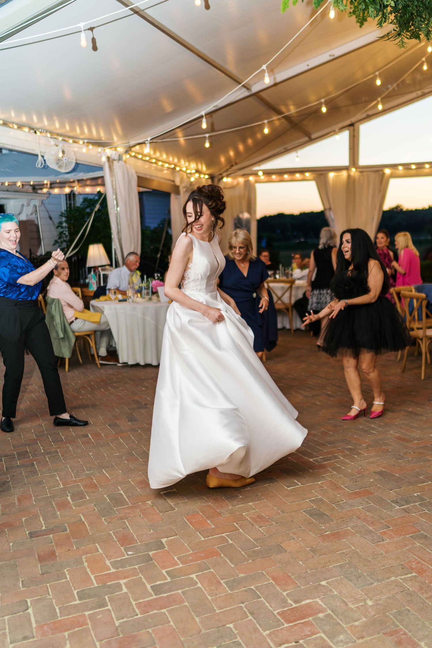 Fernbrook farms Philly wedding photography Bride twirling in white gown on brick dance floor at outdoor wedding reception