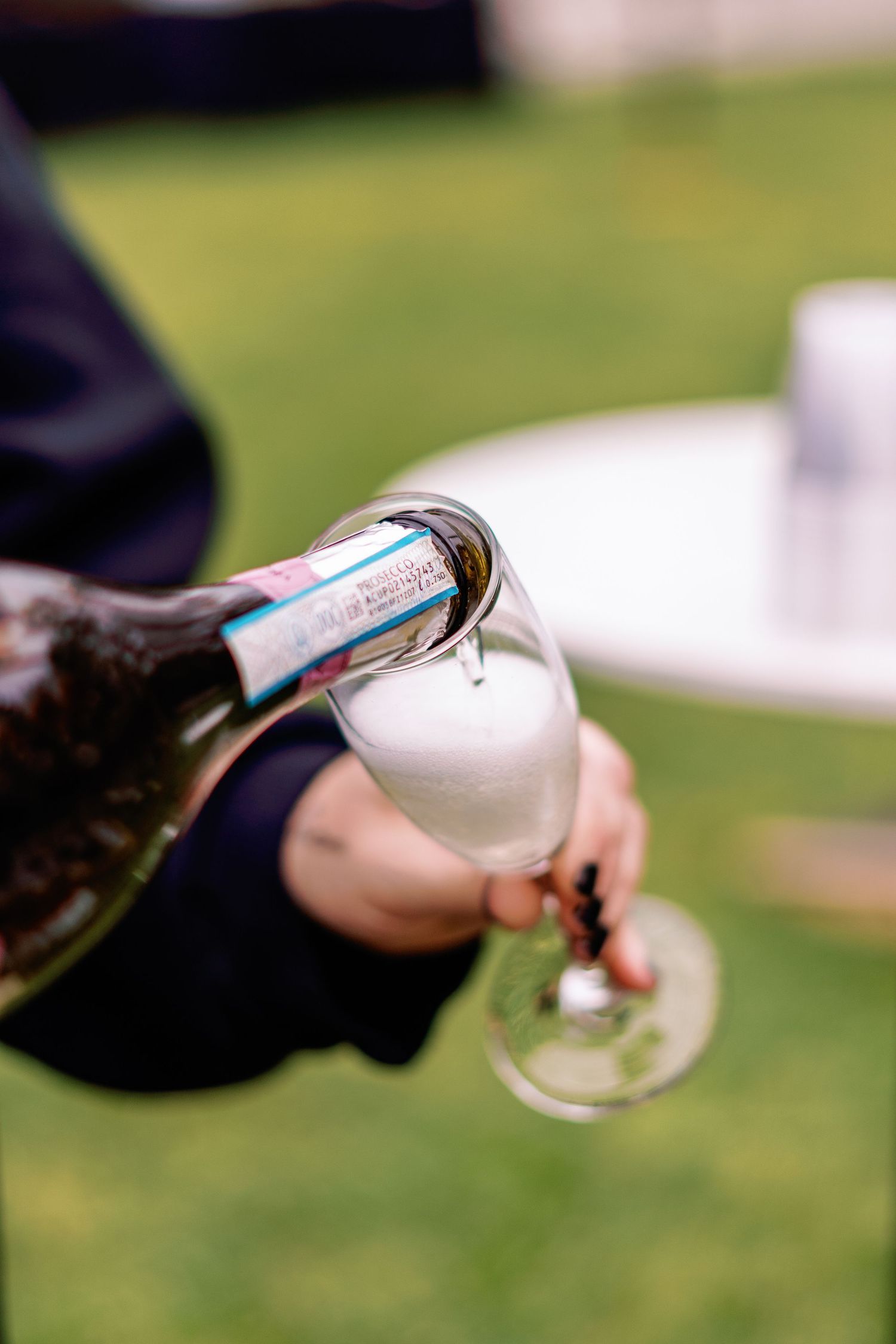 philadelphia wedding Champagne being poured into a flute glass outdoors at a celebration event.