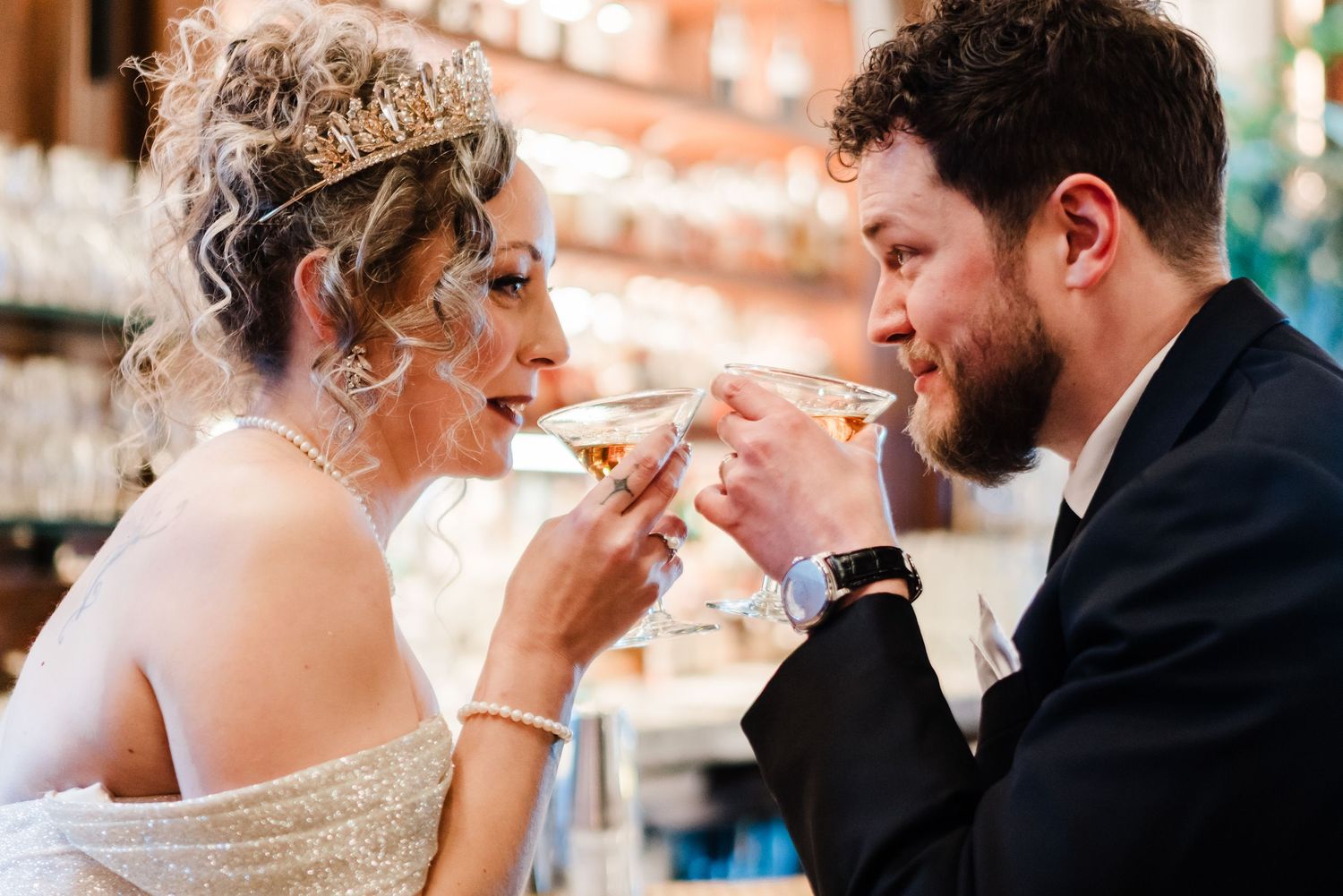 Bride and groom sharing a romantic toast, sipping from elegant glasses at their wedding reception bar Hotel DuPont wedding Philadelphia phot