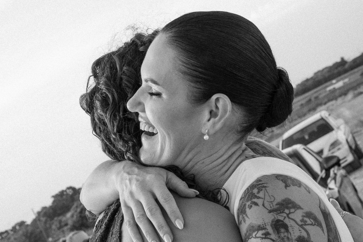 Two women sharing a joyful hug outdoors in black and white photo.

wedding, portrait