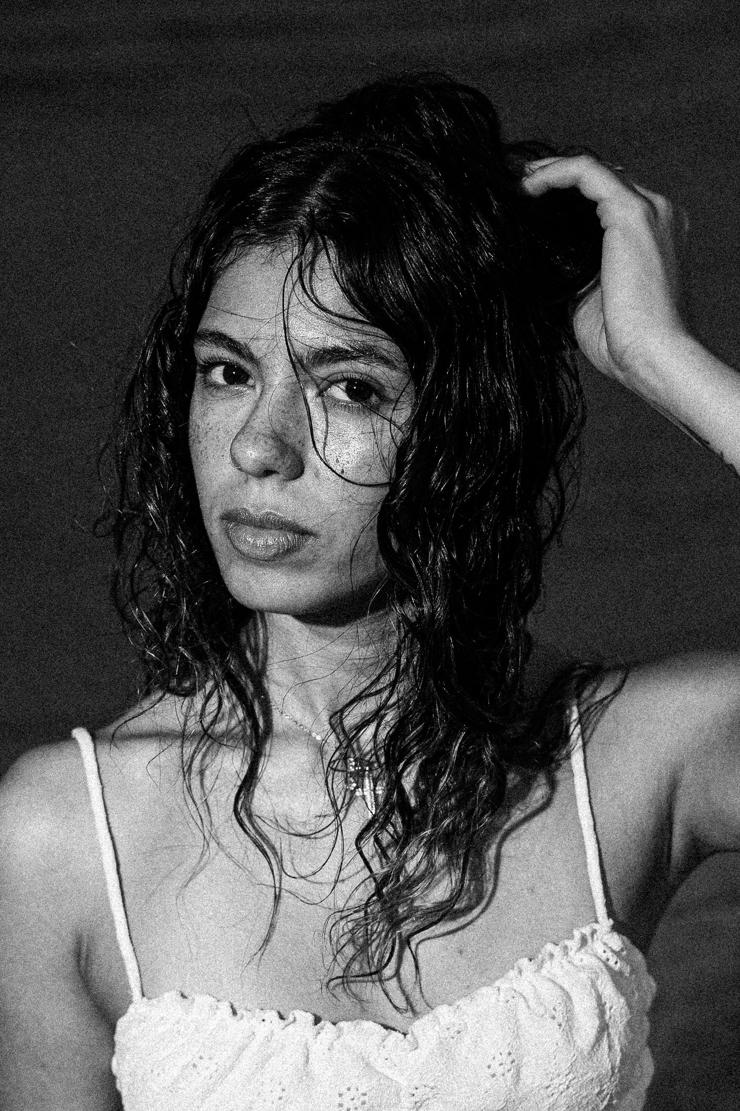 Black and white portrait of a woman with wet curly hair in a white dress.

Portrait