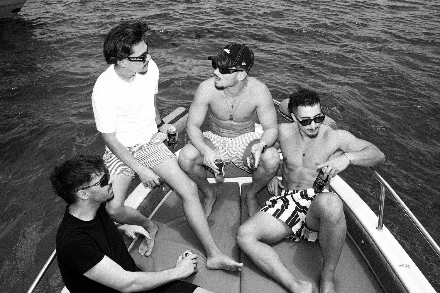 Four young men relaxing on a boat on the water in black and white photo.

lifestyle, portrait