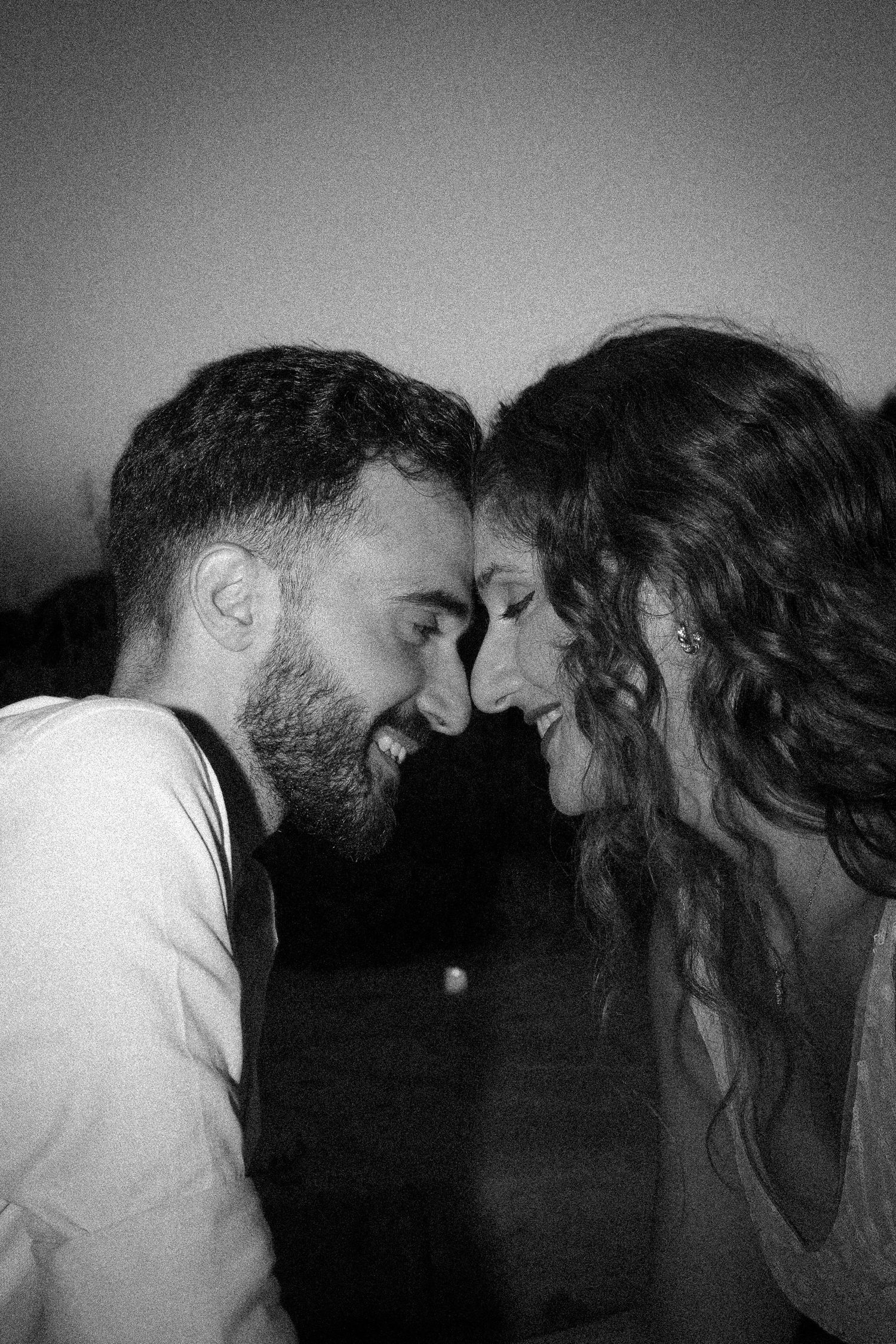 Black and white photo of a laughing couple touching foreheads romantically.

portrait, couple portrait, wedding proposal