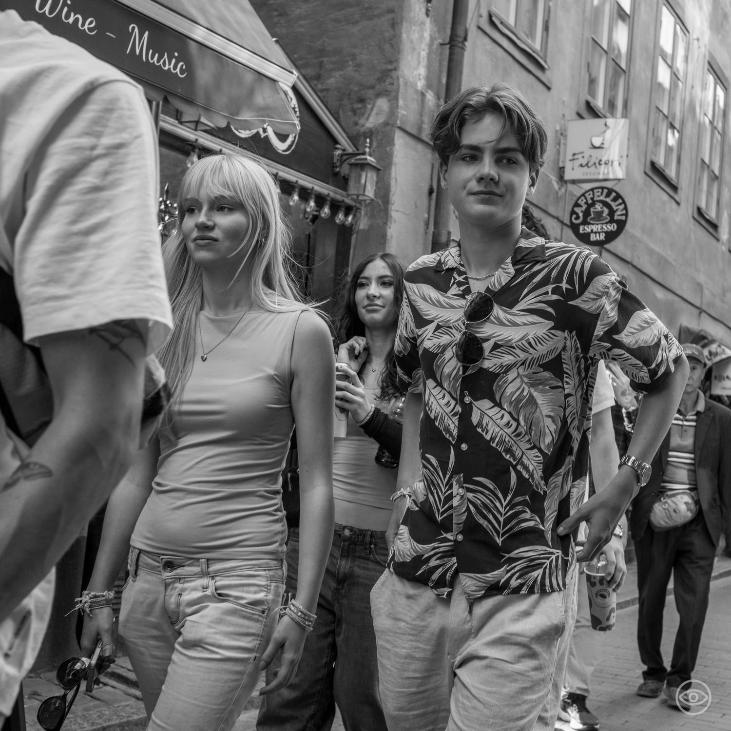 Young couple walking on a busy street, black and white street photography in urban setting.