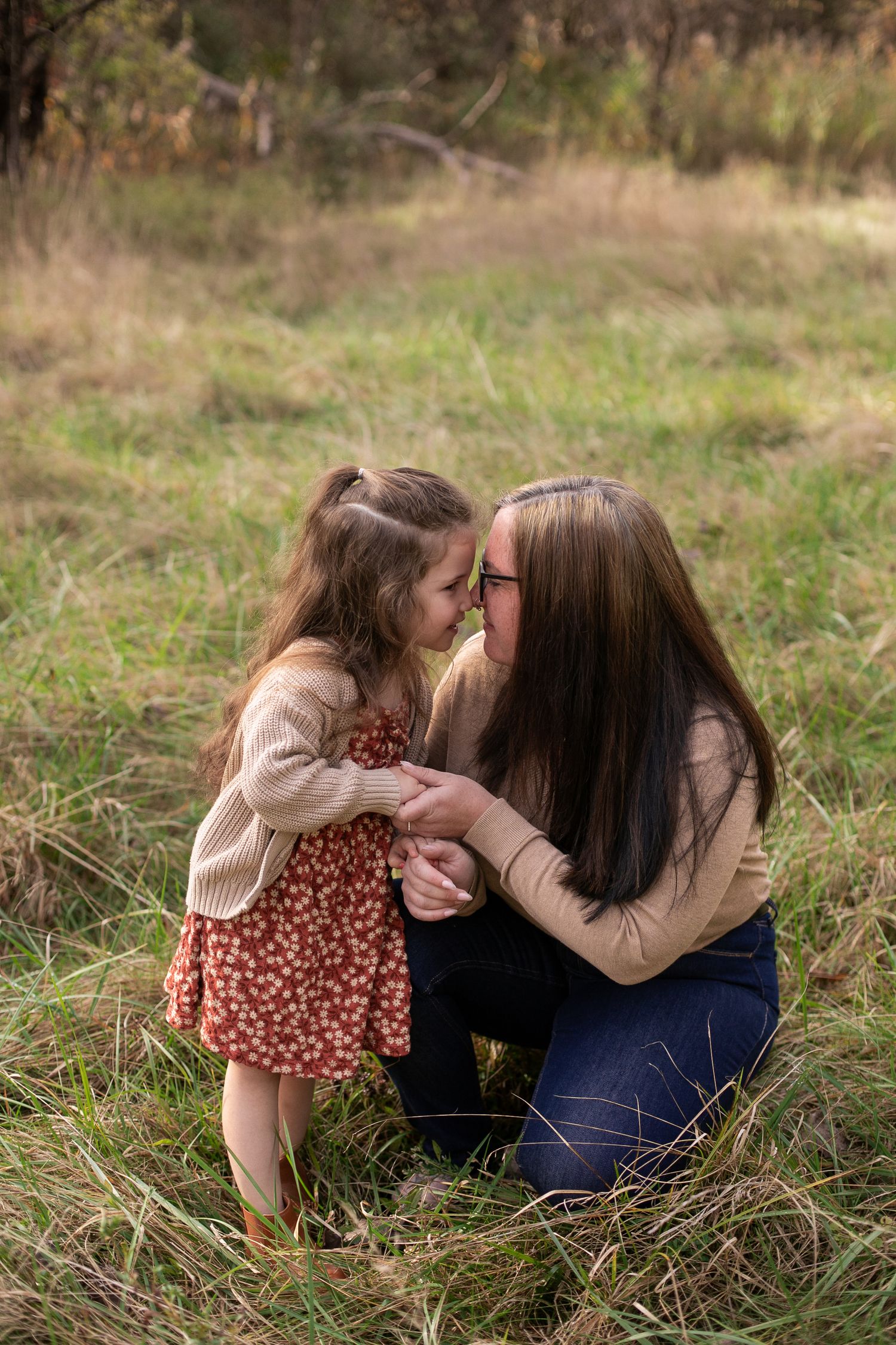 A mother and young daughter share a tender nose-to-nose moment. Mini session in the fields of Syracuse NY by Candid House Studios