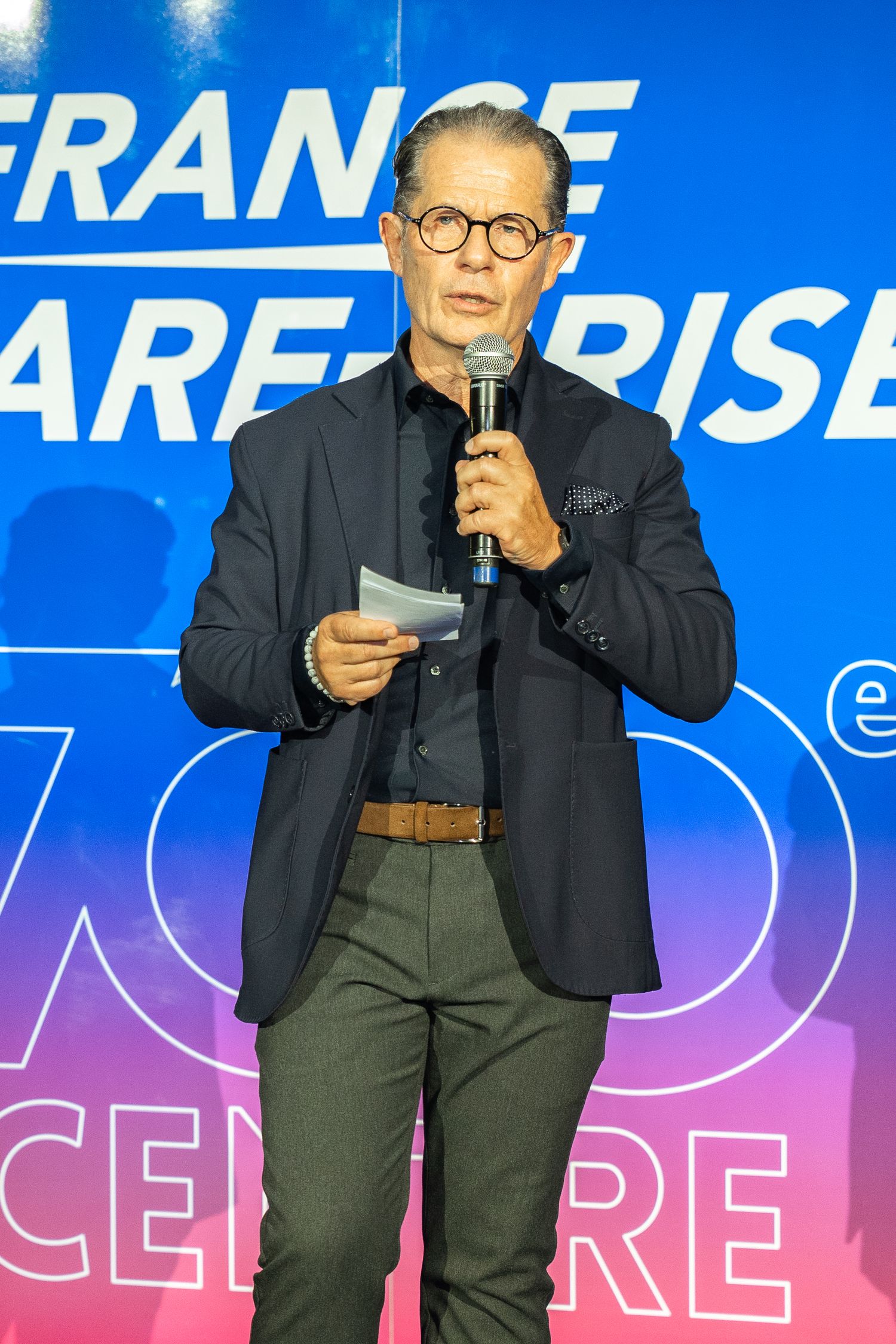 Discours d'inauguration devant un décor lumineux aux couleurs de l'entreprise — photographe événementiel entreprise Lorraine