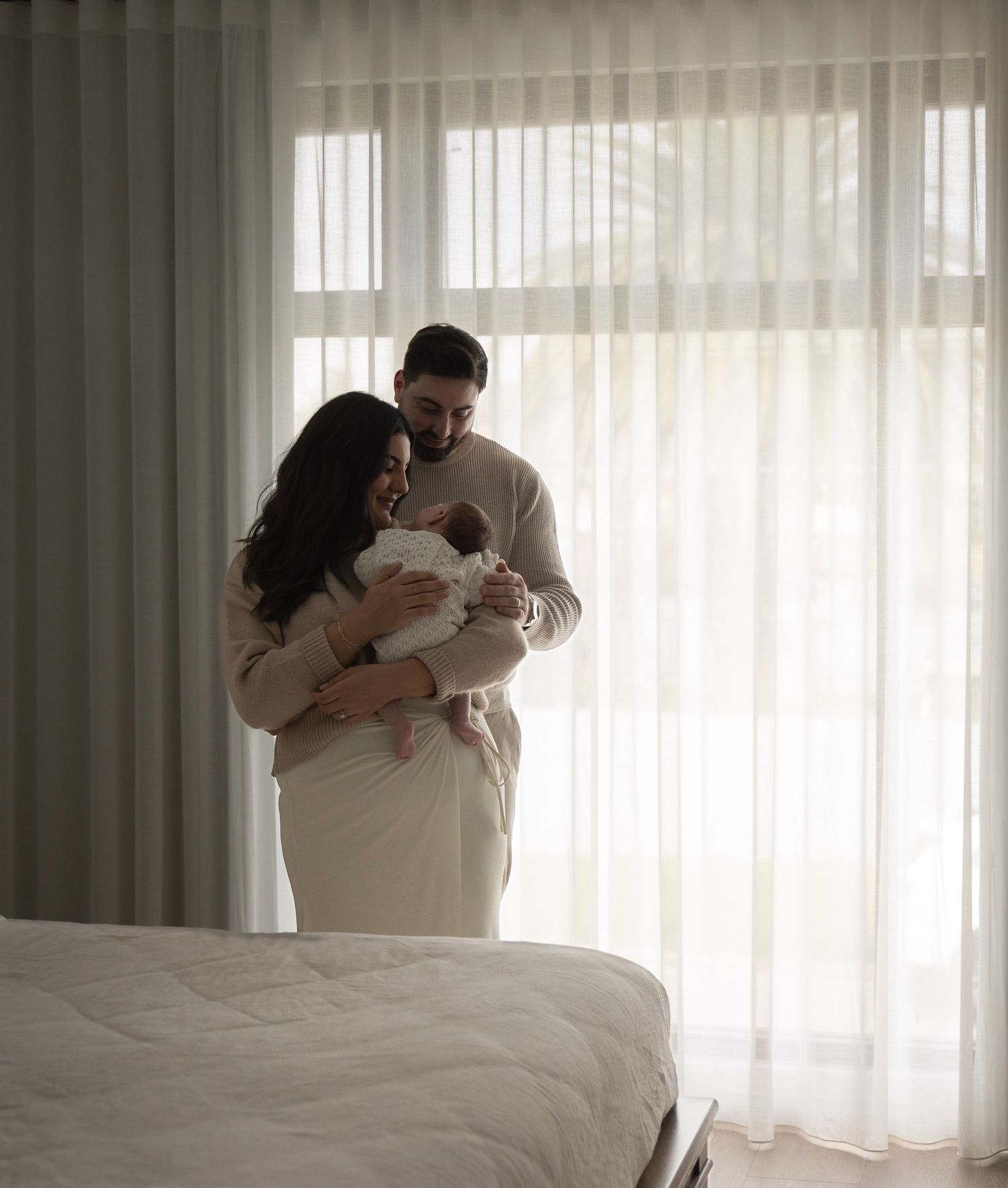 newborn home photography session western adelaide parents holding baby