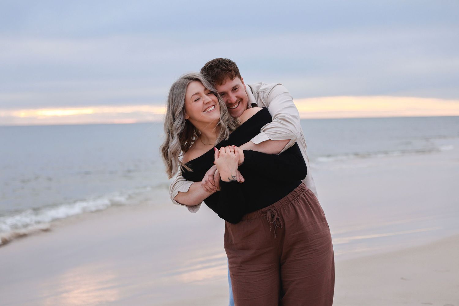couple embracing west beach adelaide