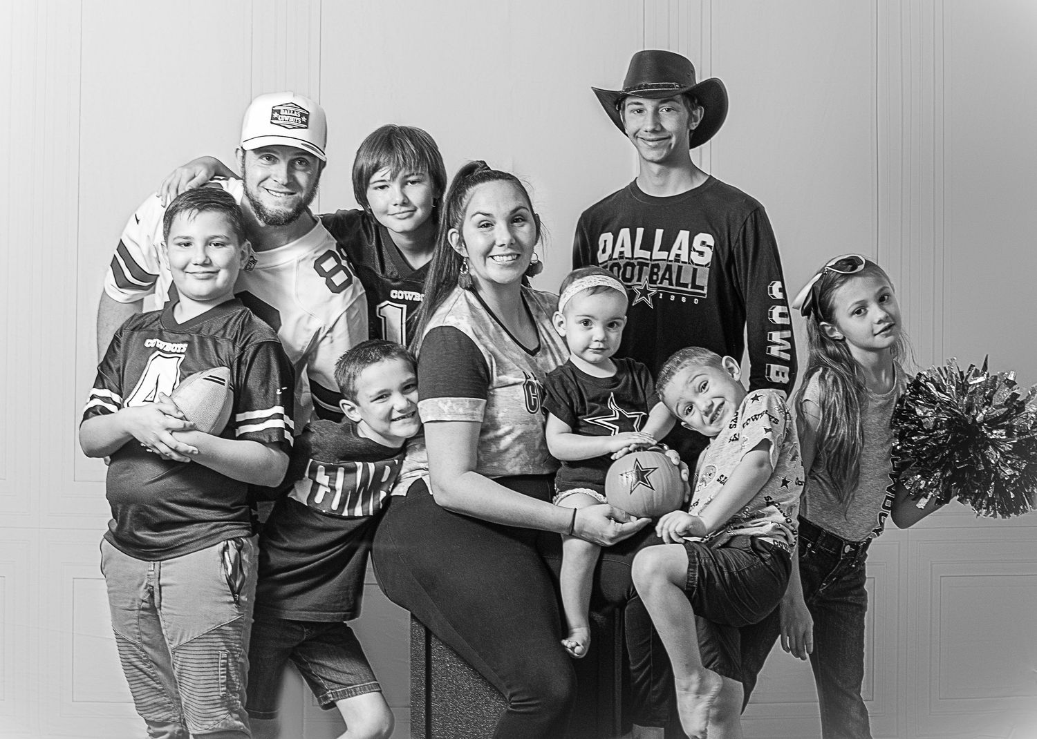 Large family portrait in black and white during an outdoor milestone session by Tiny Toes to Tassels Photography