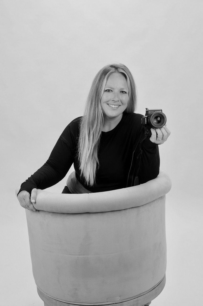 Dana, professional portrait photographer holding a camera during a studio session for Tiny Toes to Tassels Photography in Springtown, TX