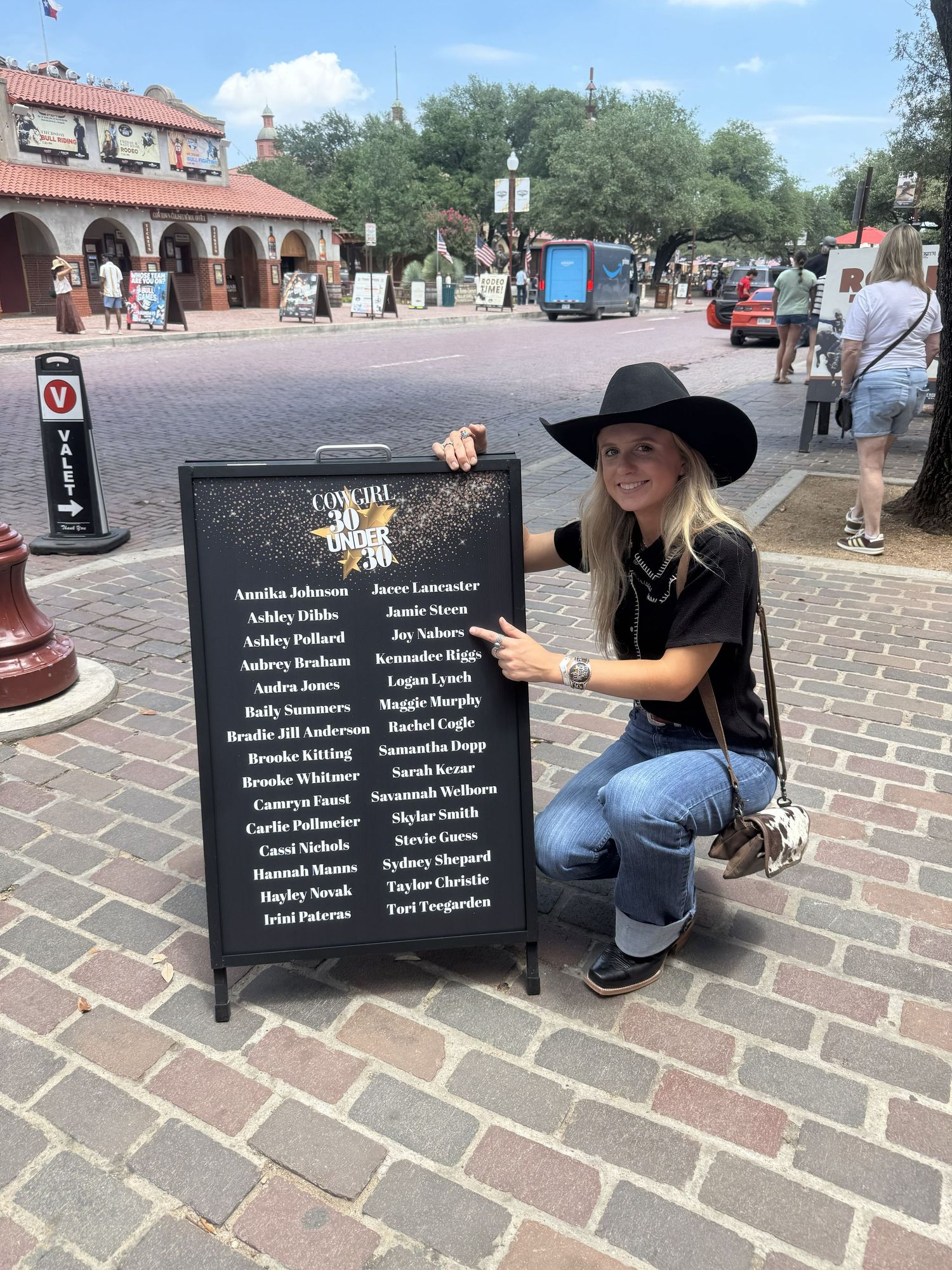 Picture of Joy Nabors beside her Cowgirl 30 Under 30 recognition sign.