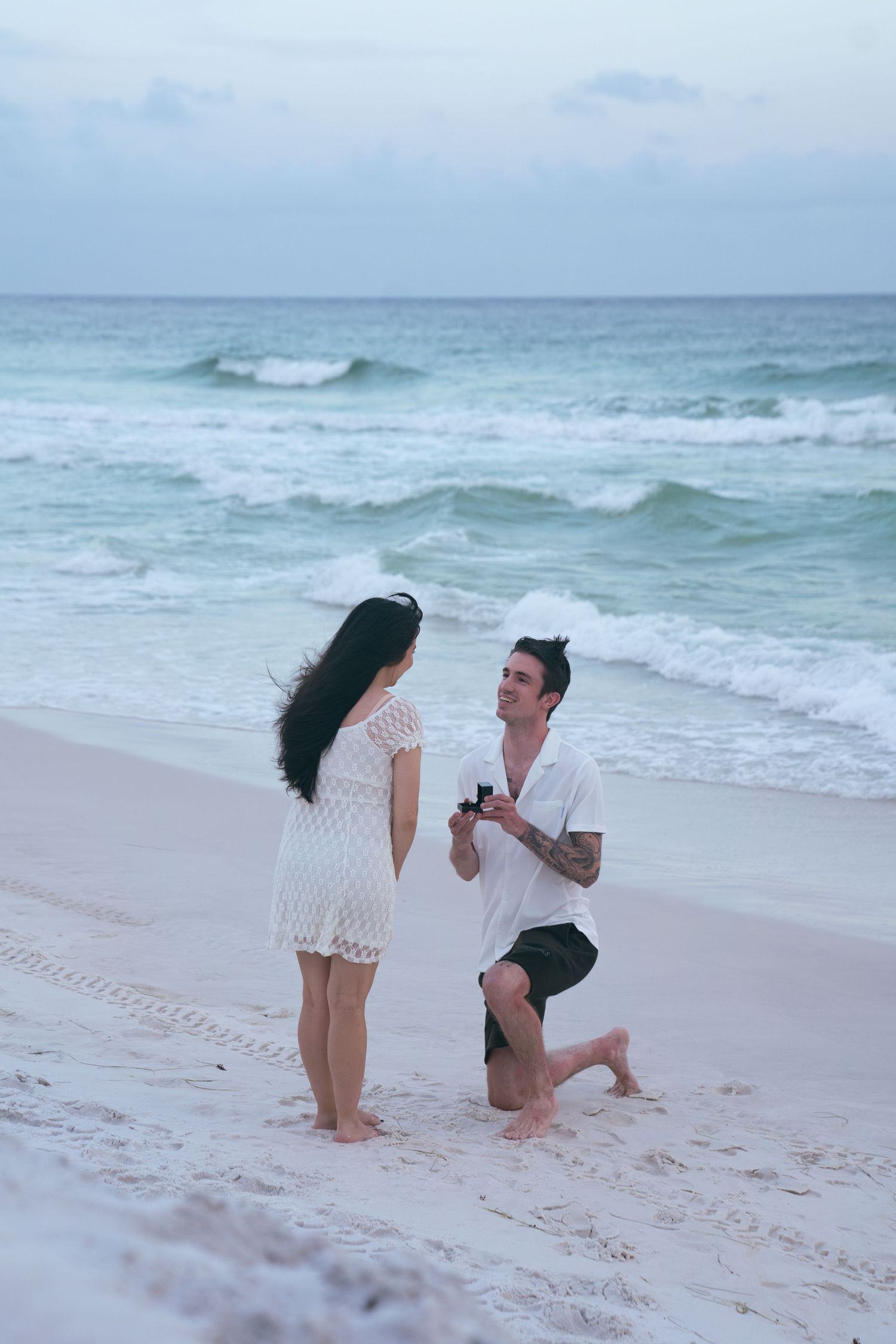 Beach engagement photography in Destin, Florida, featuring a couple during a romantic Gulf Coast sunset.