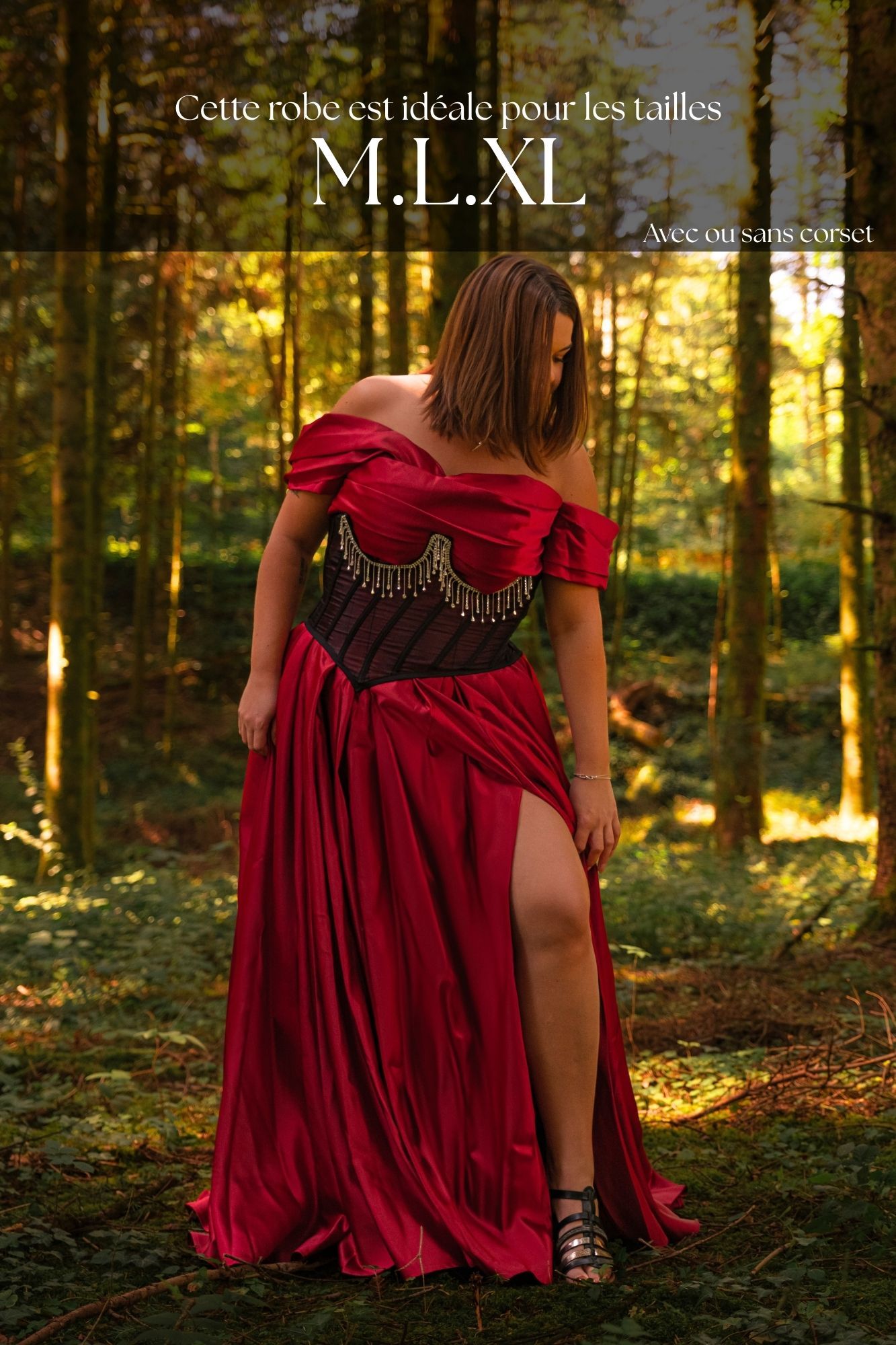 Woman in red off-shoulder gown with corset detail poses in forest, available in sizes M, L, XL.