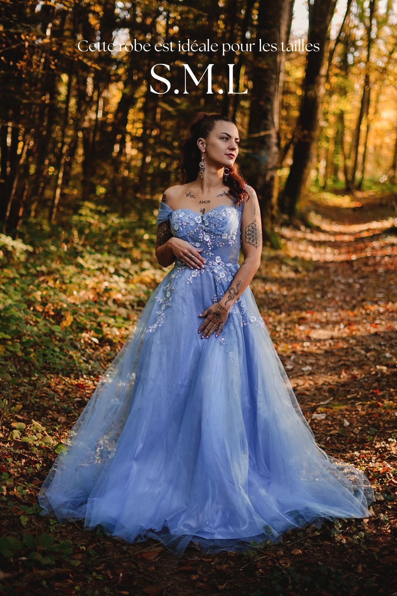 Woman in blue off-shoulder floral tulle gown in autumn forest, ideal for sizes S, M, L.