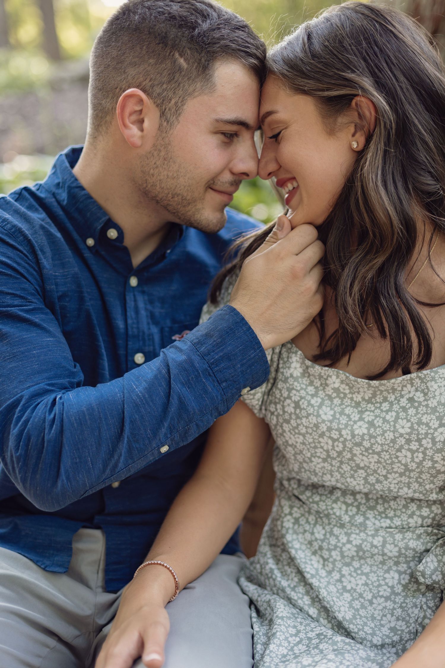 A couple shares an intimate moment outdoors wearing blue denim and floral patterns in a romantic photoshoot sequence.