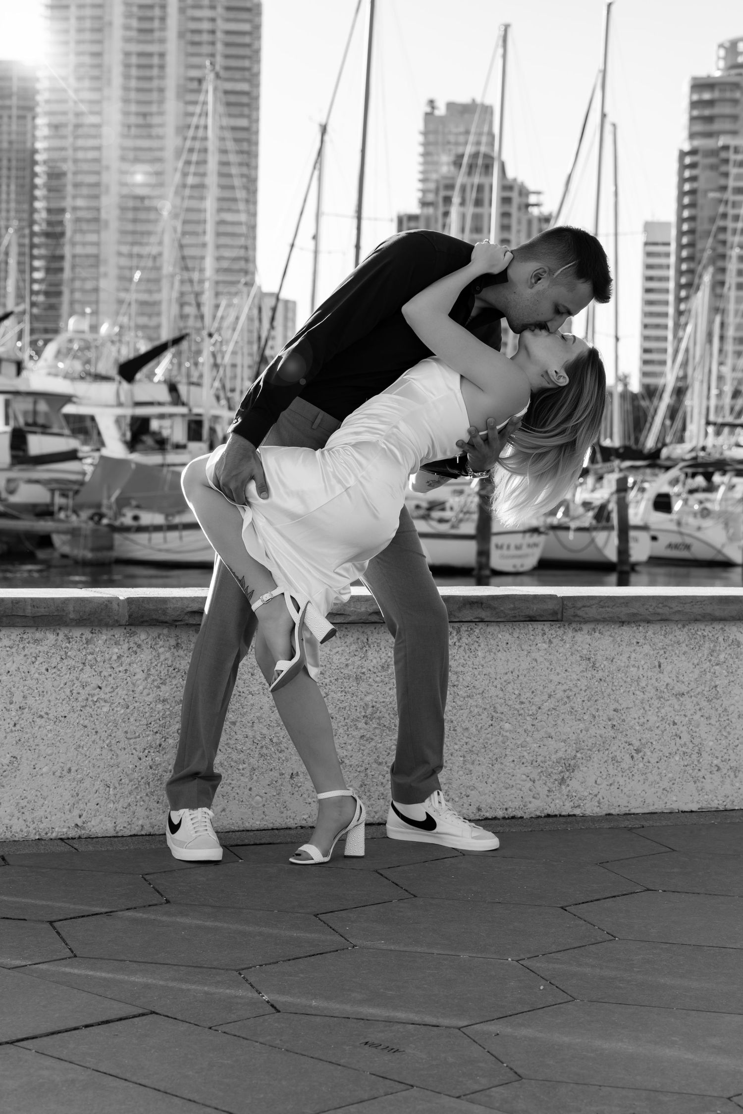 A sequence showing someone breakdancing on pavement near a marina with boats and buildings in the background.