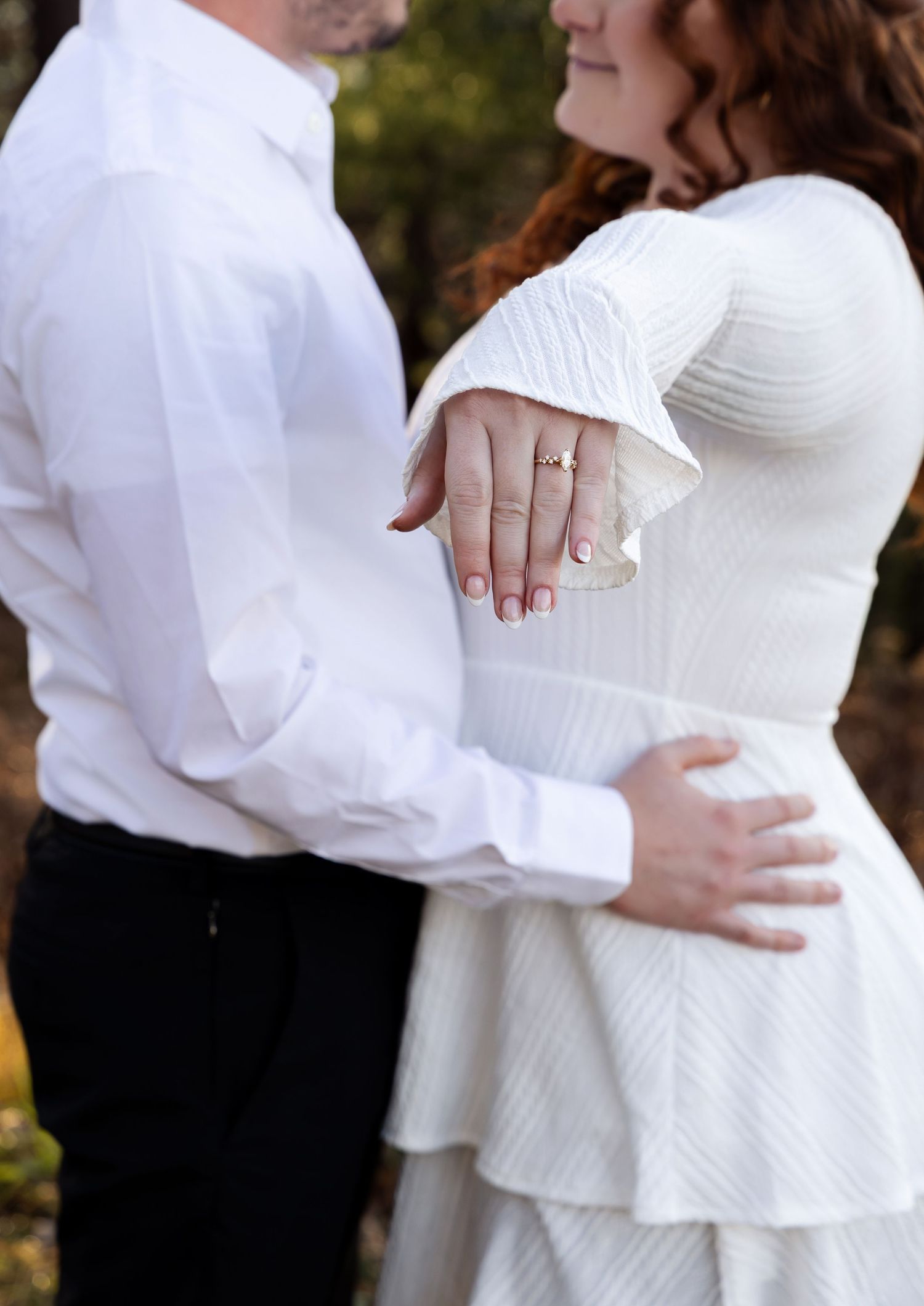 A couple in white attire embraces in a romantic outdoor photoshoot showing multiple intimate poses.