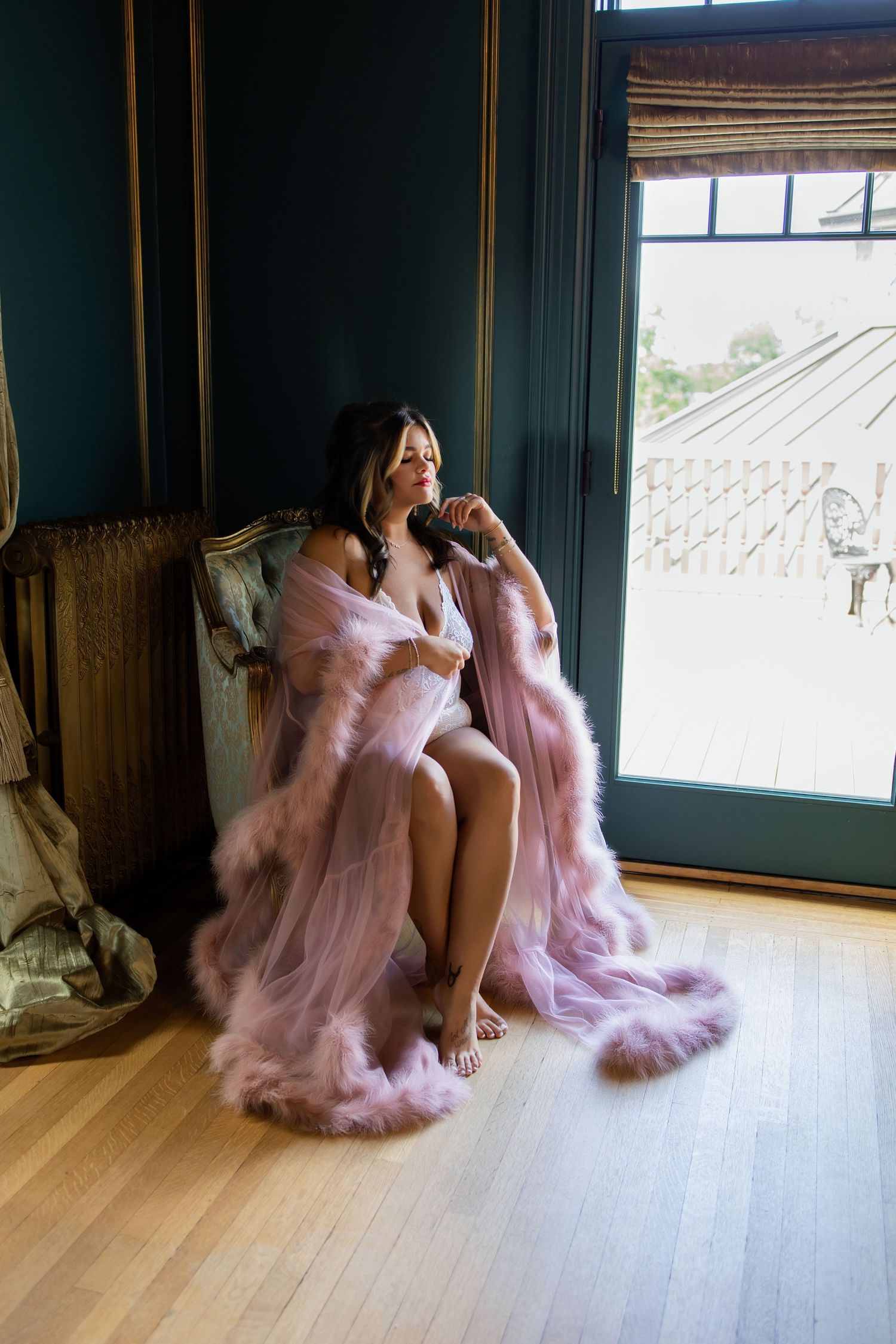A series of four photos showing a figure in a flowing pink tulle dress moving gracefully across a wooden floor.