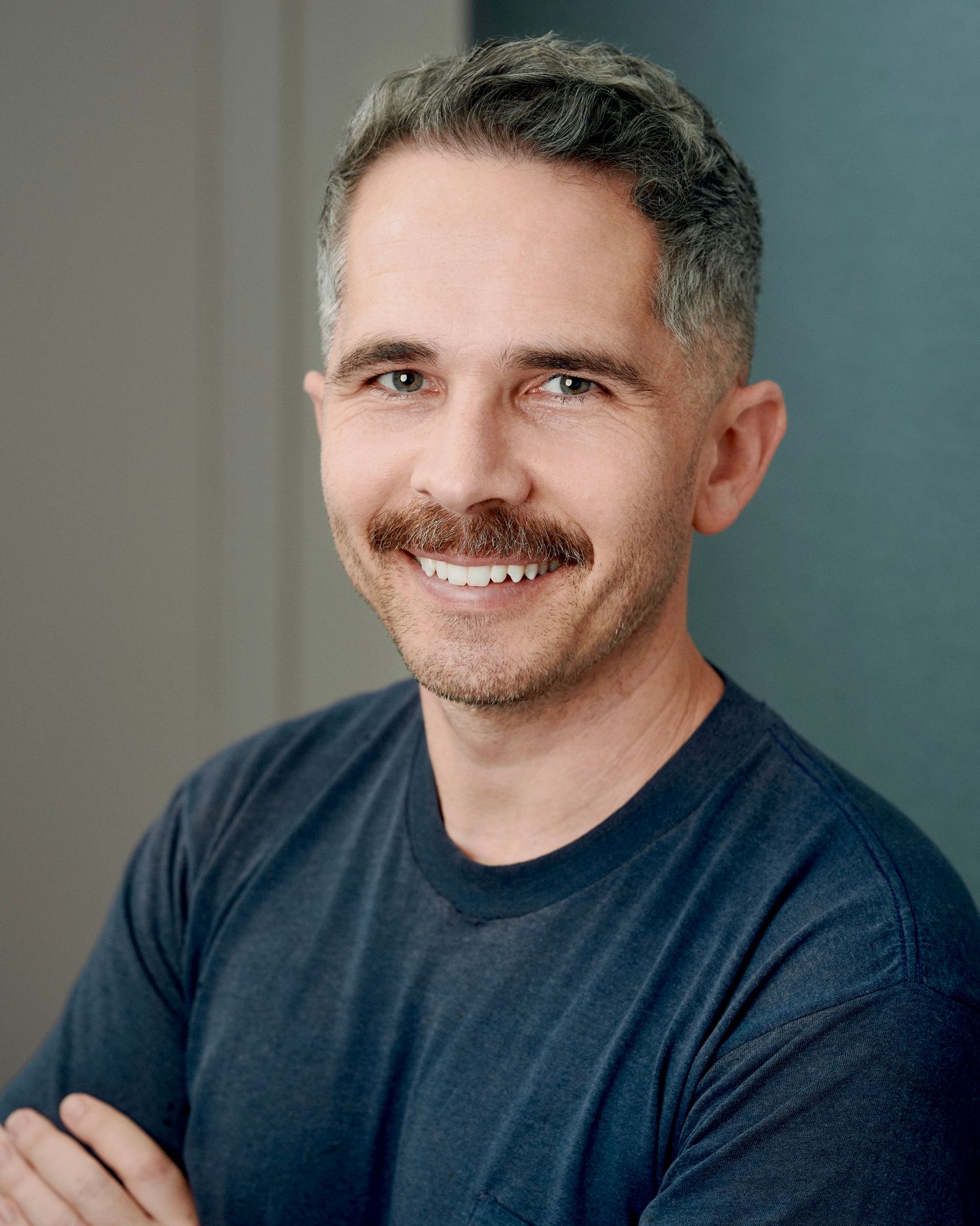 Relaxed corporate headshot with warm smile against soft background — portrait by Los Angeles photographer Afonso Salcedo