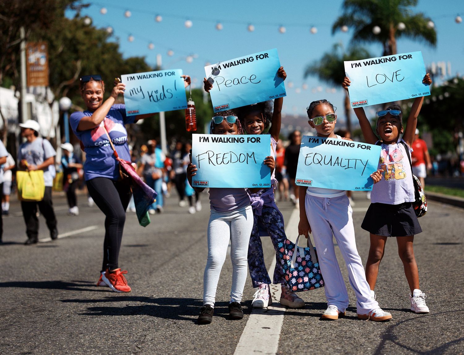 Children hold signs at AIDS Walk Los Angeles, Oct. 2025. (Afonso Salcedo)