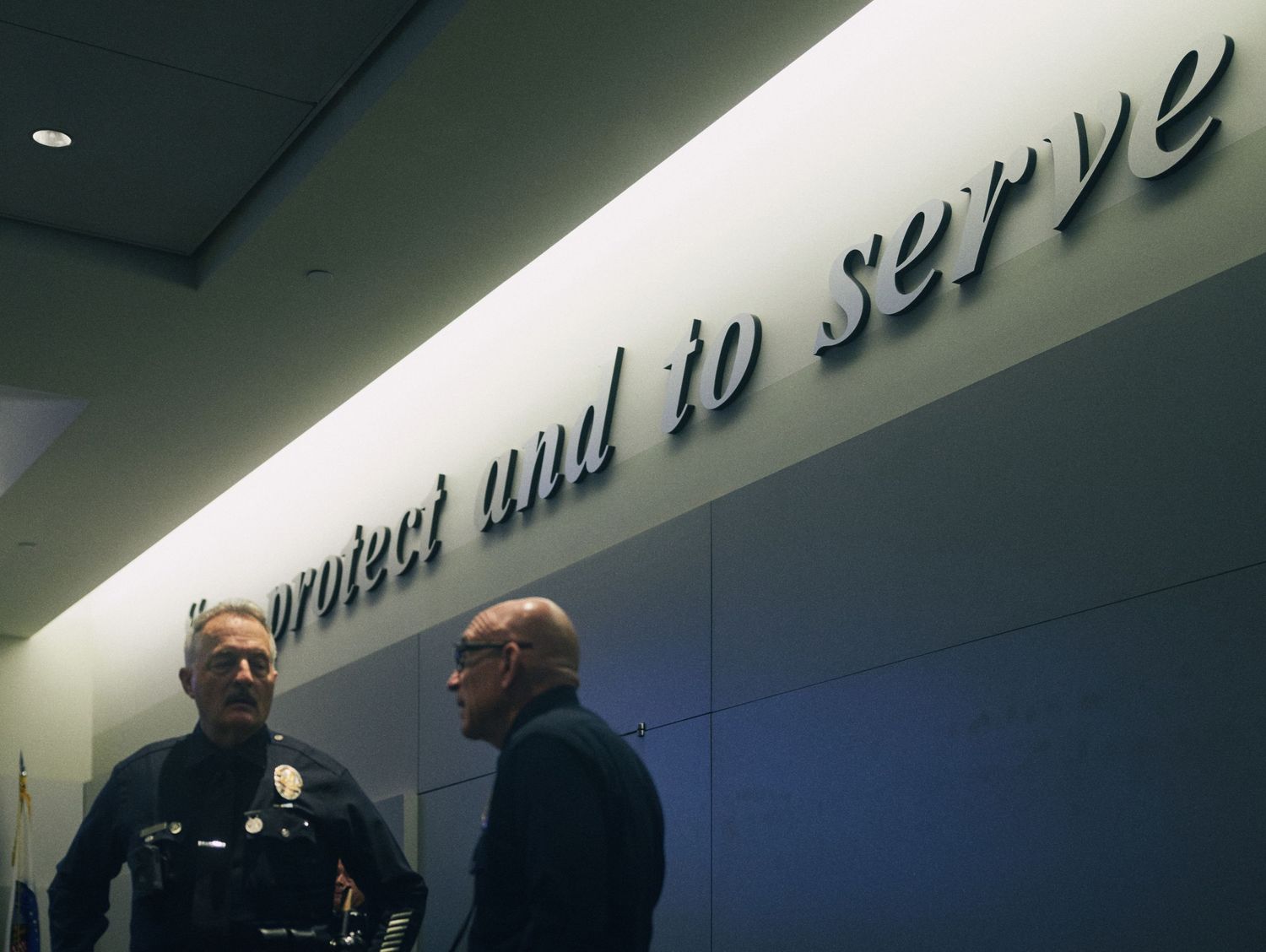 Two officers stand beneath a 