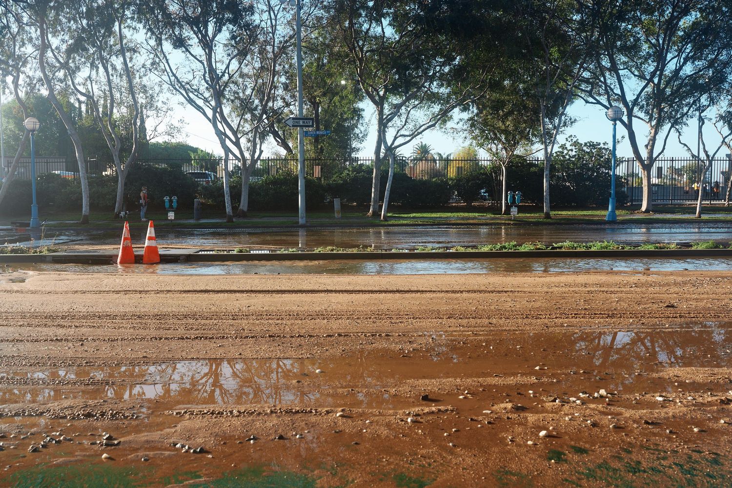 Debris and standing water remain on Santa Monica Boulevard as cleanup begins following the West Hollywood water main break