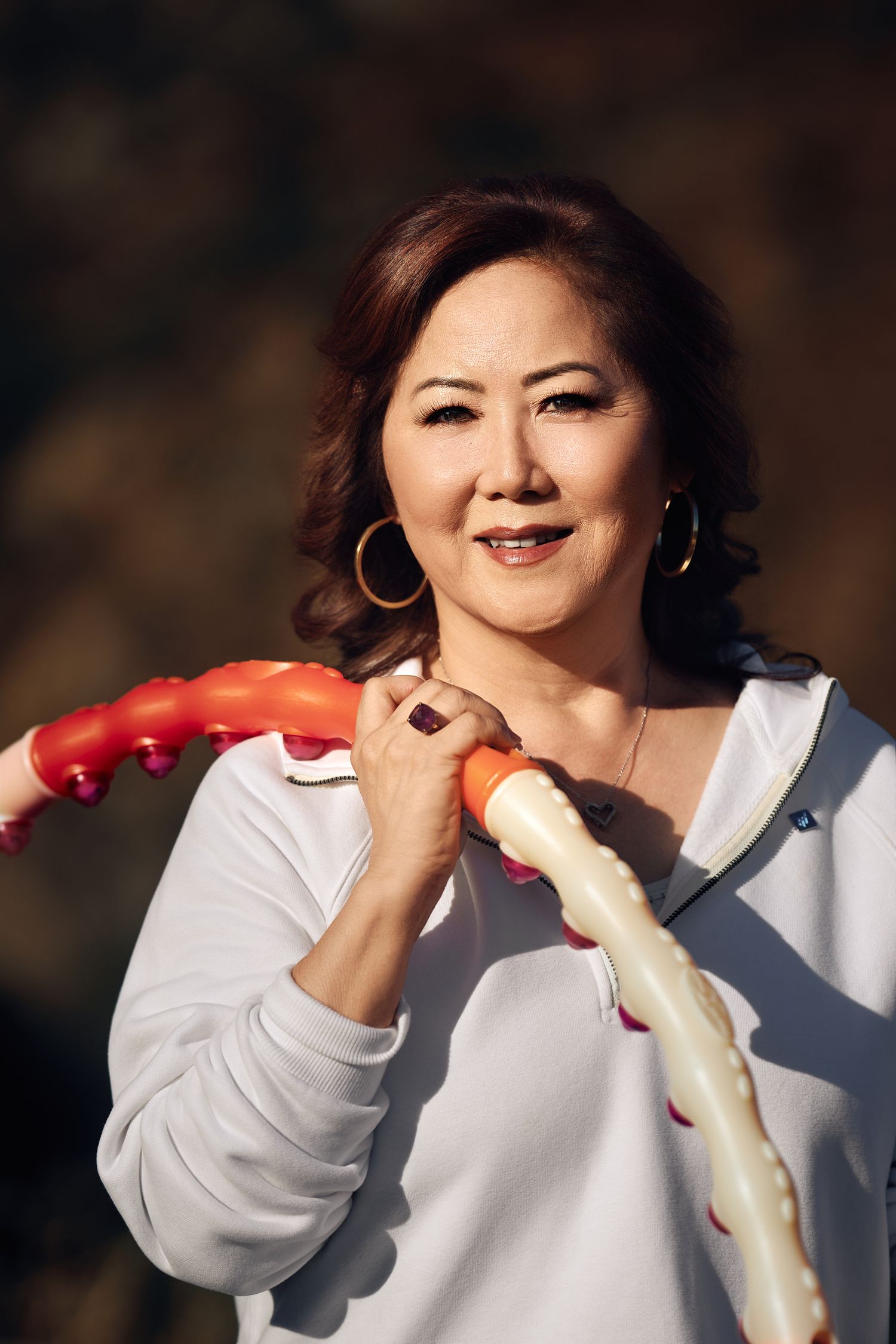 Portrait of Sunny Han-Jeon holding a hula hoop over her shoulder on Mt. Wilson Trail, photographed for the Journal of Corporate Renewal.