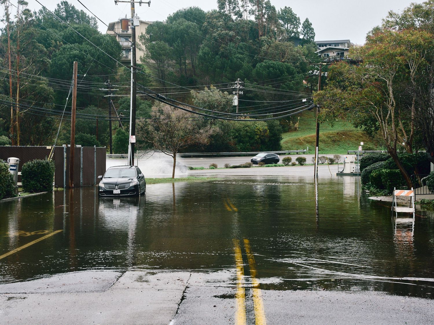 A vehicle sits in floodwaters at Tiburon Blvd. and Blackfield Dr. in Tiburon, Calif., Jan. 3, 2026. (Afonso Salcedo)