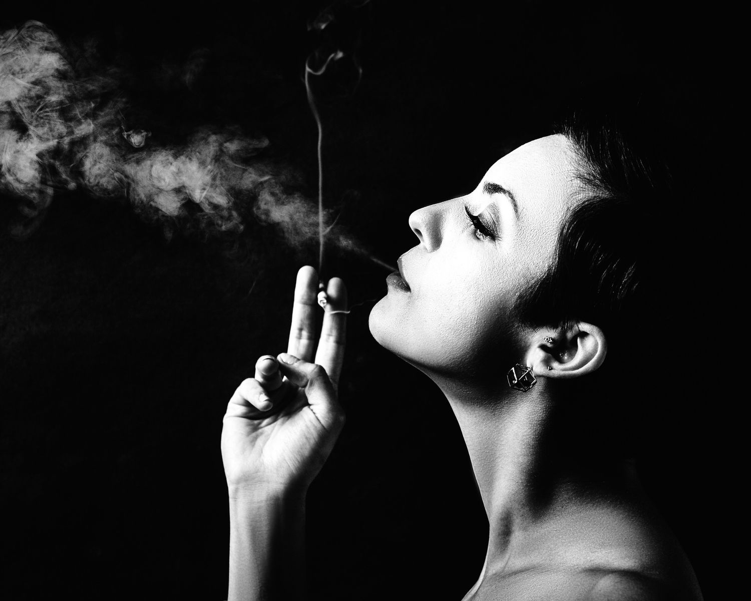 Black and white editorial portrait with cigarette smoke — creative portrait by Los Angeles photographer Afonso Salcedo