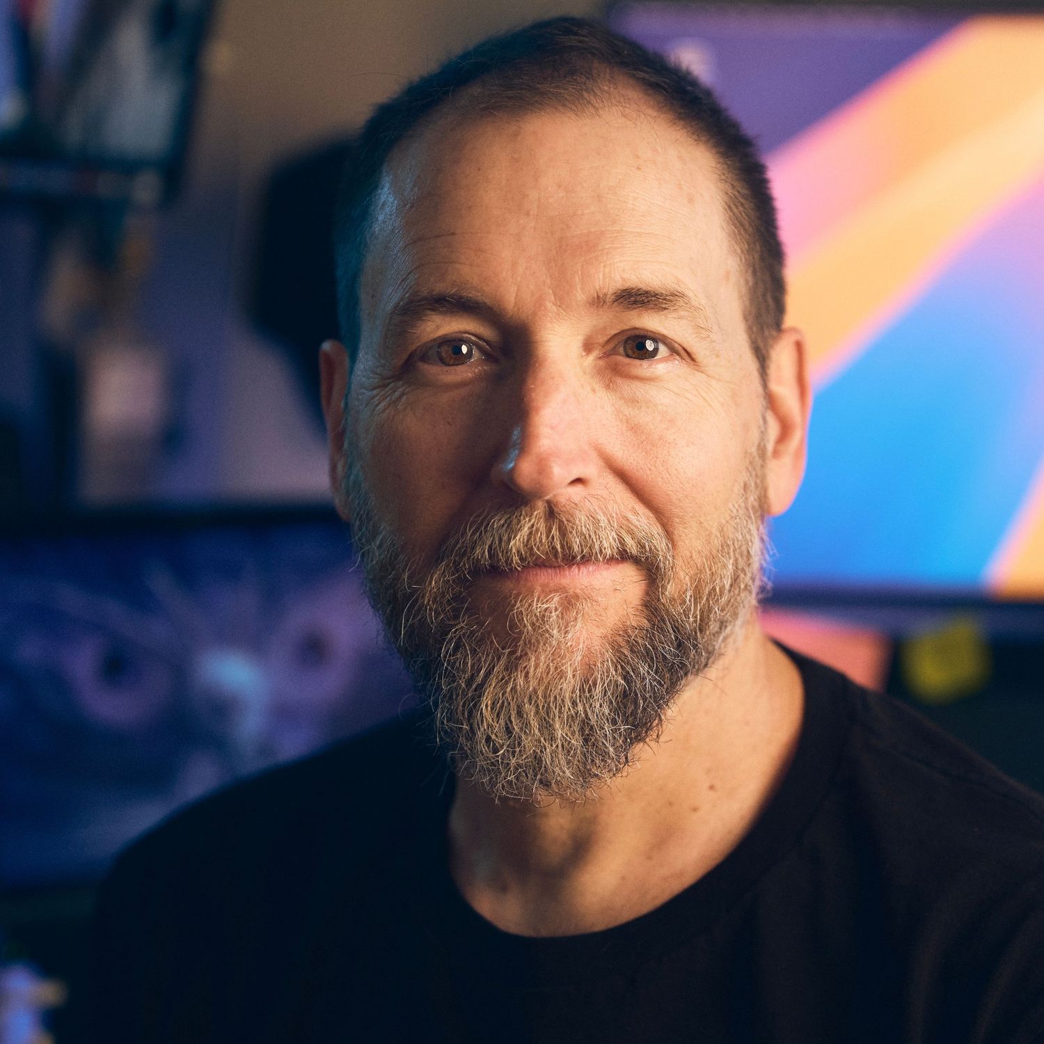 Environmental headshot of Andrew Schmidt with colorful workspace background — portrait by Los Angeles photographer Afonso Salcedo
