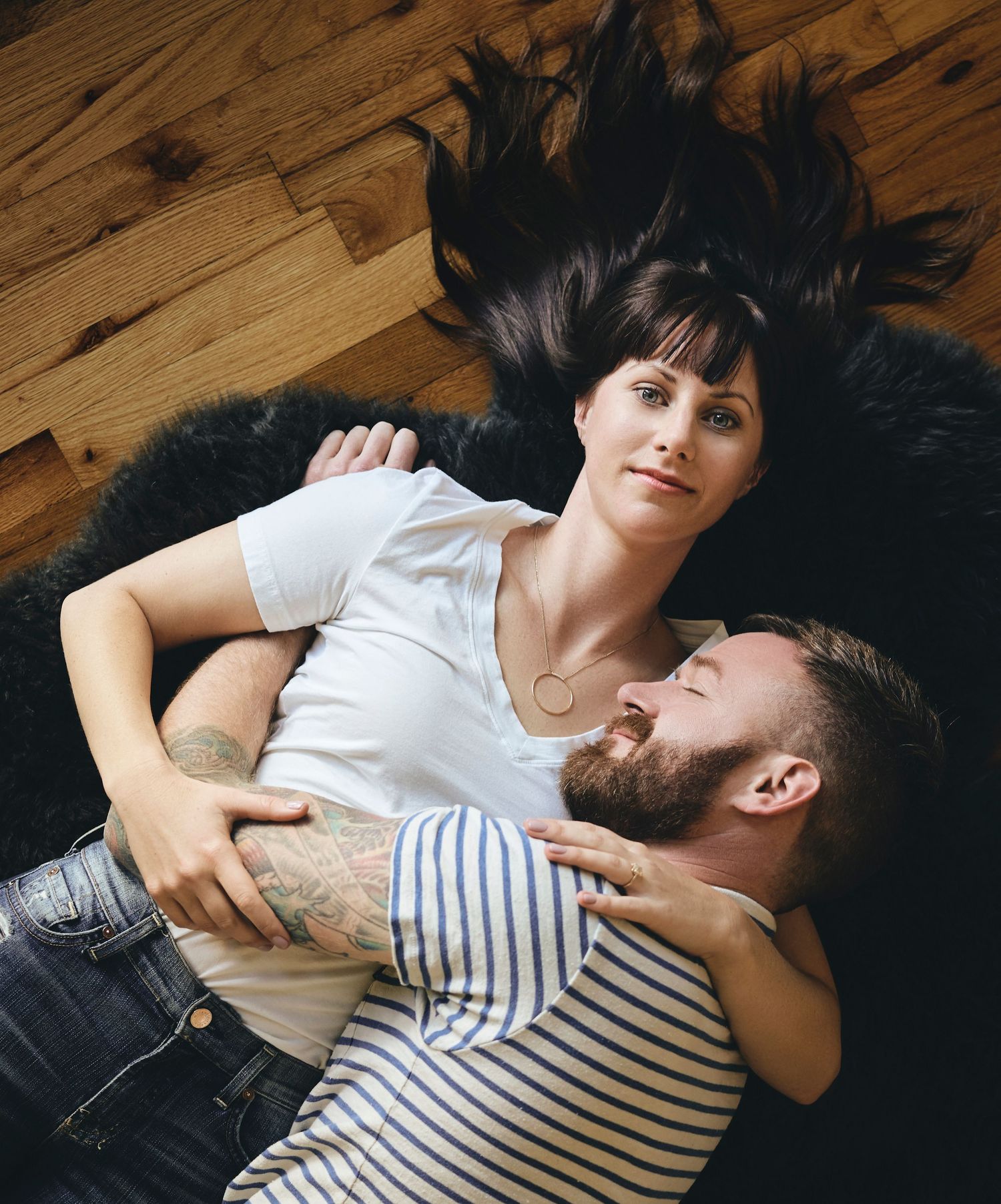 Intimate overhead couple portrait on hardwood floor — editorial portrait by Los Angeles photographer Afonso Salcedo