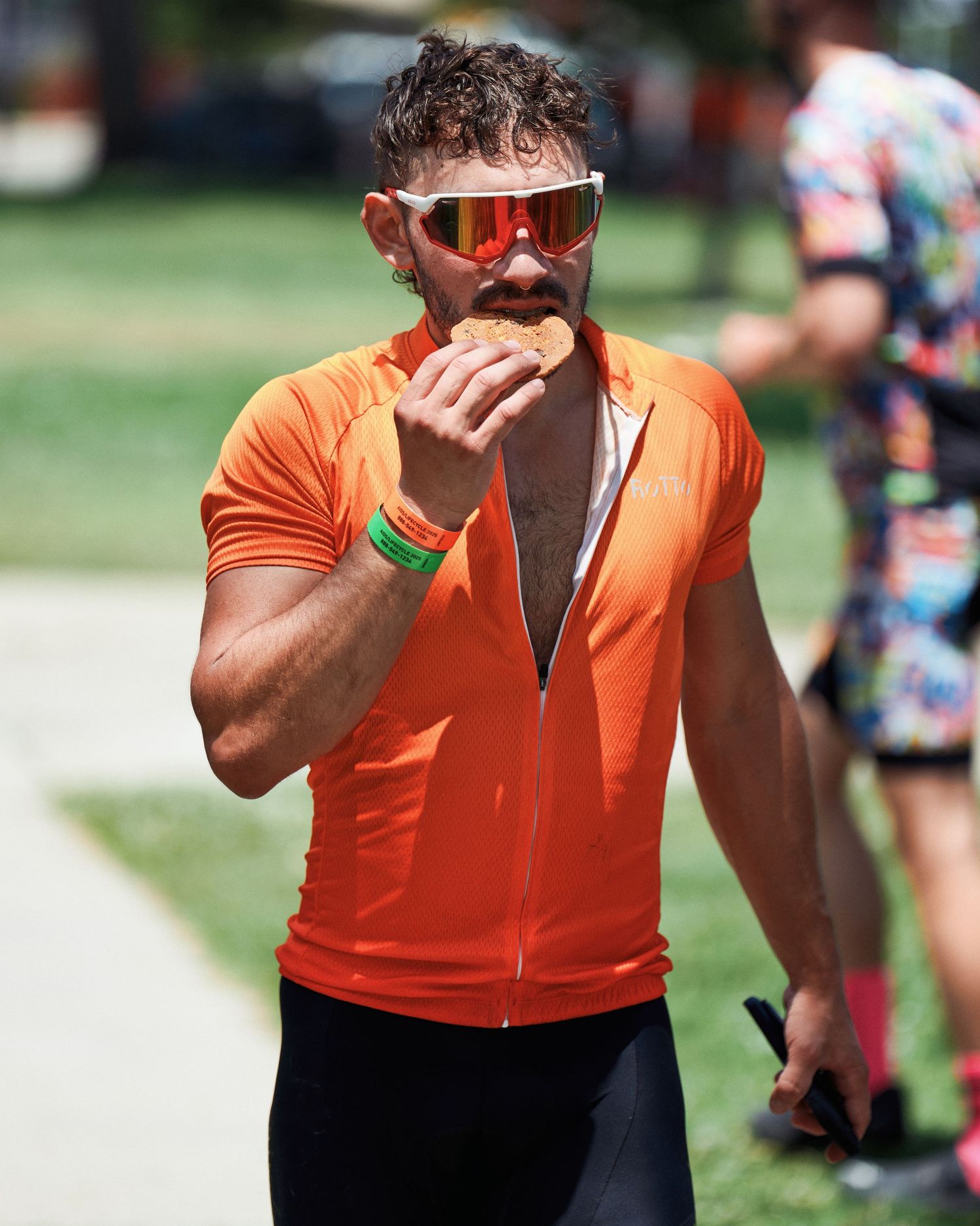 Person in bright orange athletic wear shown from the shoulders down in several sequential shots.