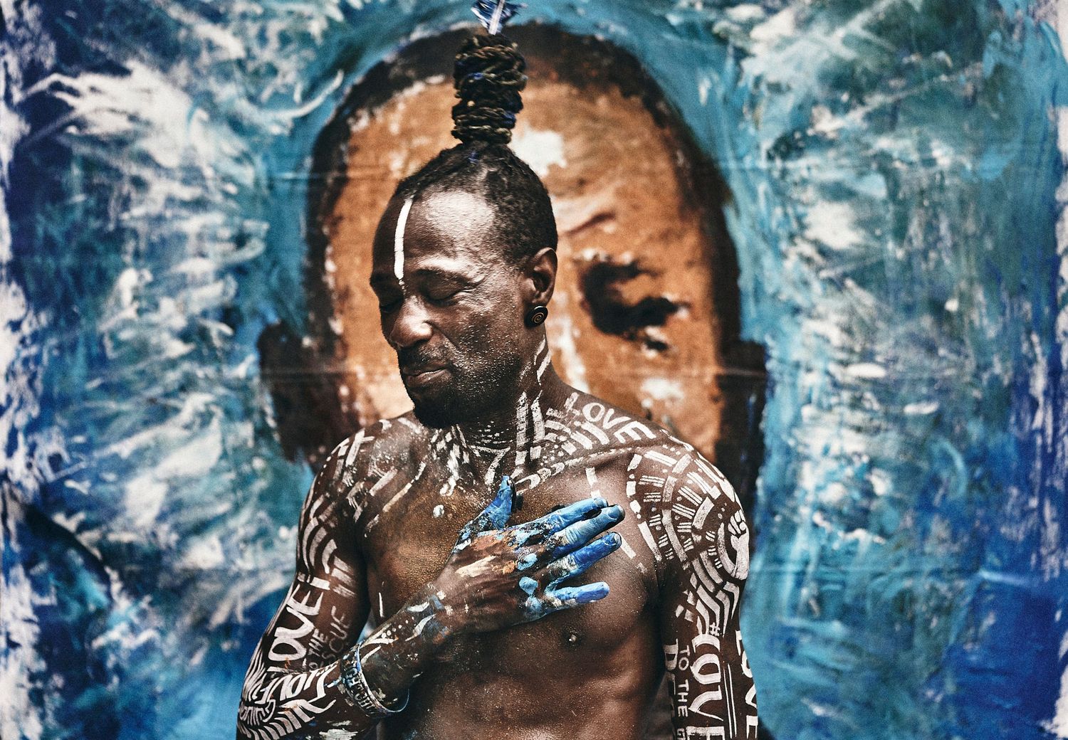 Artist Rio stands before his George Floyd mural during a BLM demonstration in Hollywood, June 2020. (Afonso Salcedo)